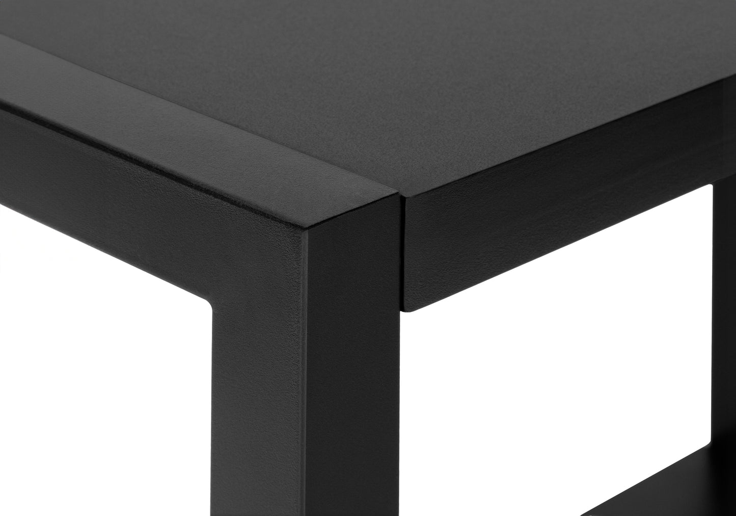 Closeup of a black metal side table corner showcasing its minimalist design and matte finish
