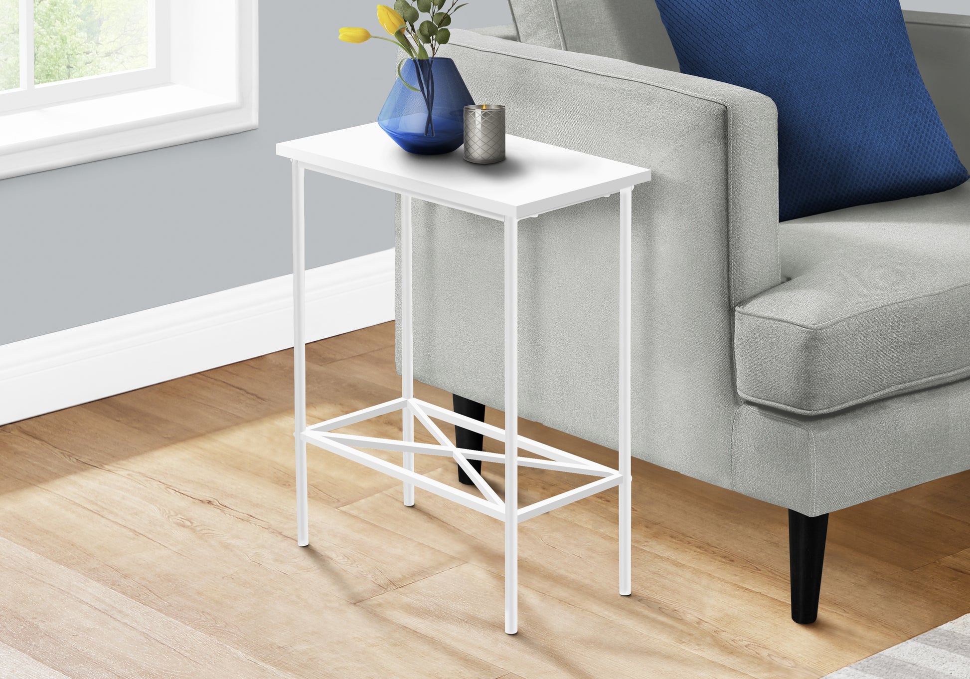 White metal side table with clean lines perfect for small spaces next to a sofa
