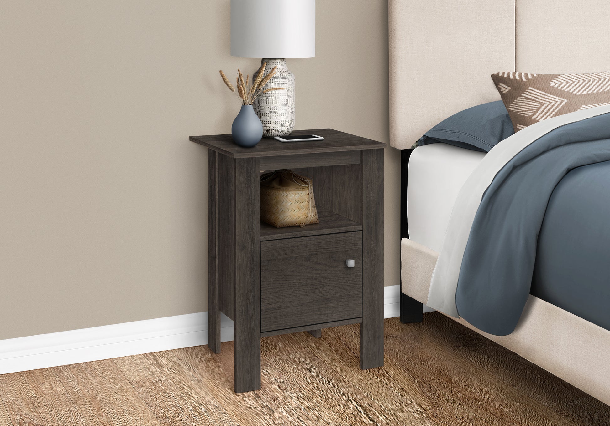 Dark gray wood nightstand with open shelf and drawer beside a bed