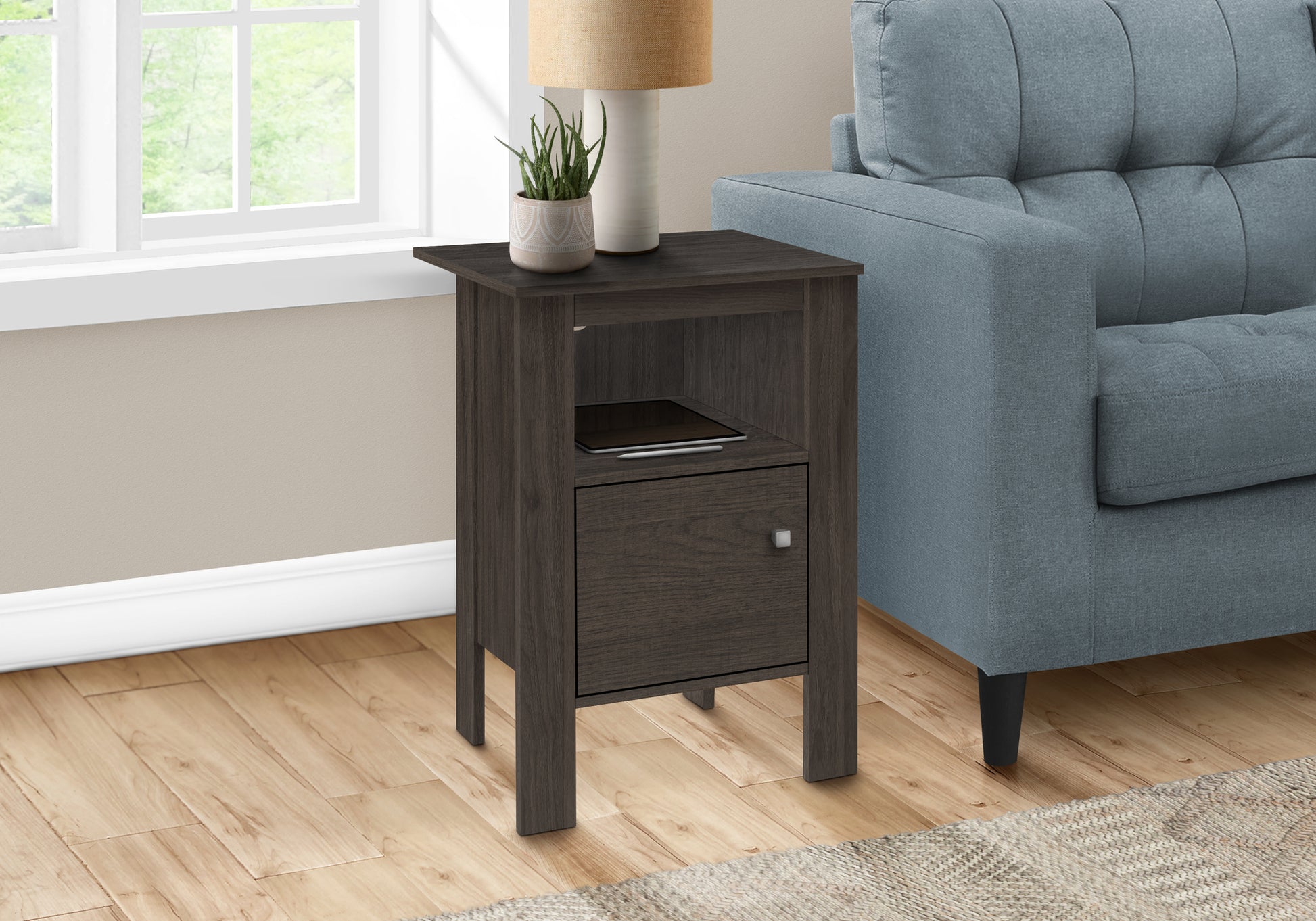 Dark wood nightstand with one drawer and open shelf beside a blue sofa