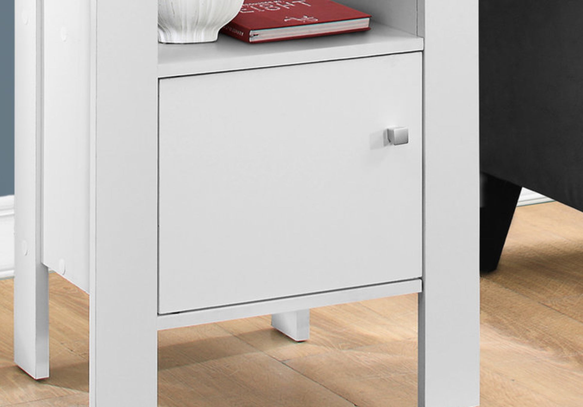 White MDF nightstand with silver square knob and a red book on top