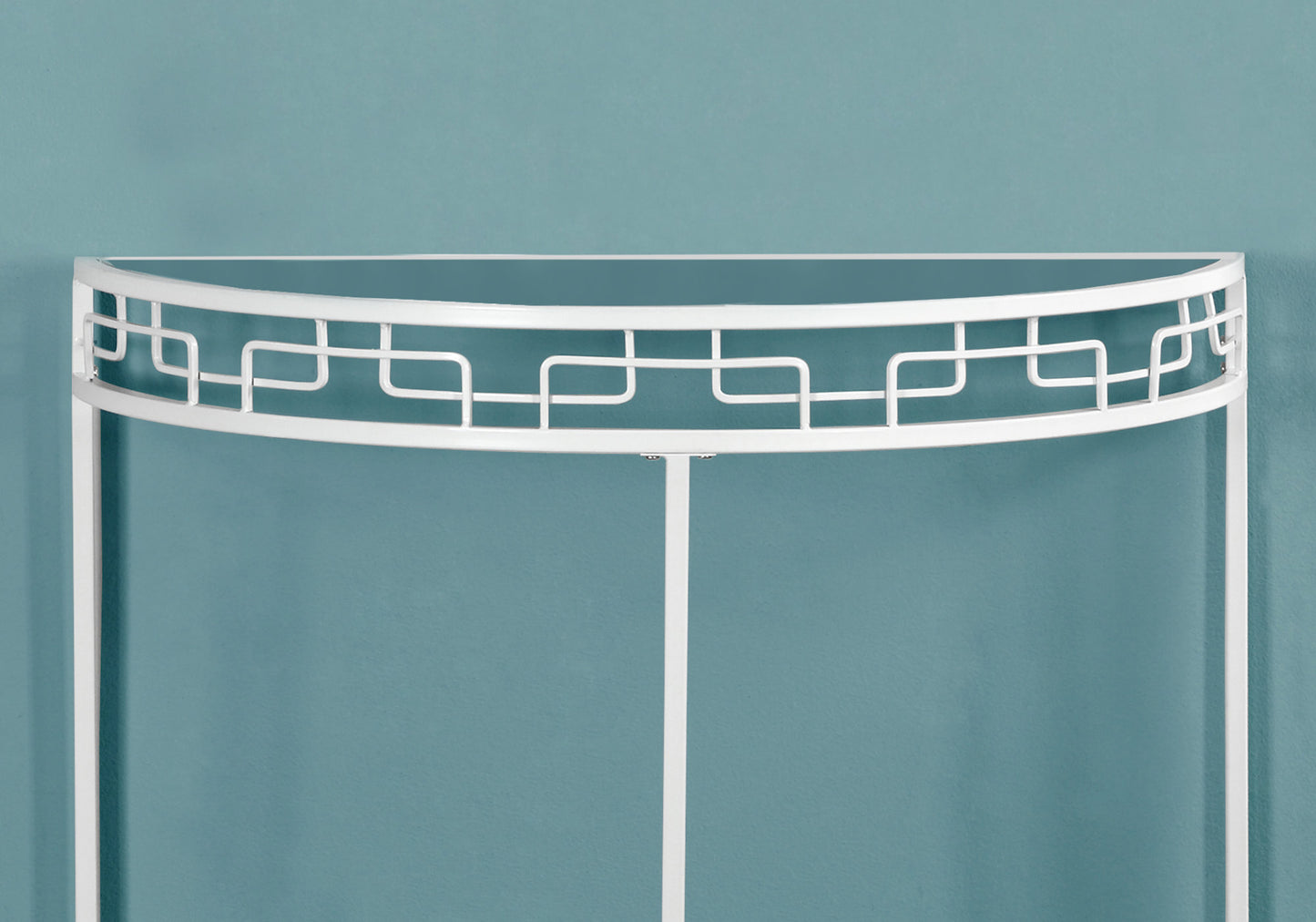 White metal console table with ornate geometric detailing and glass top