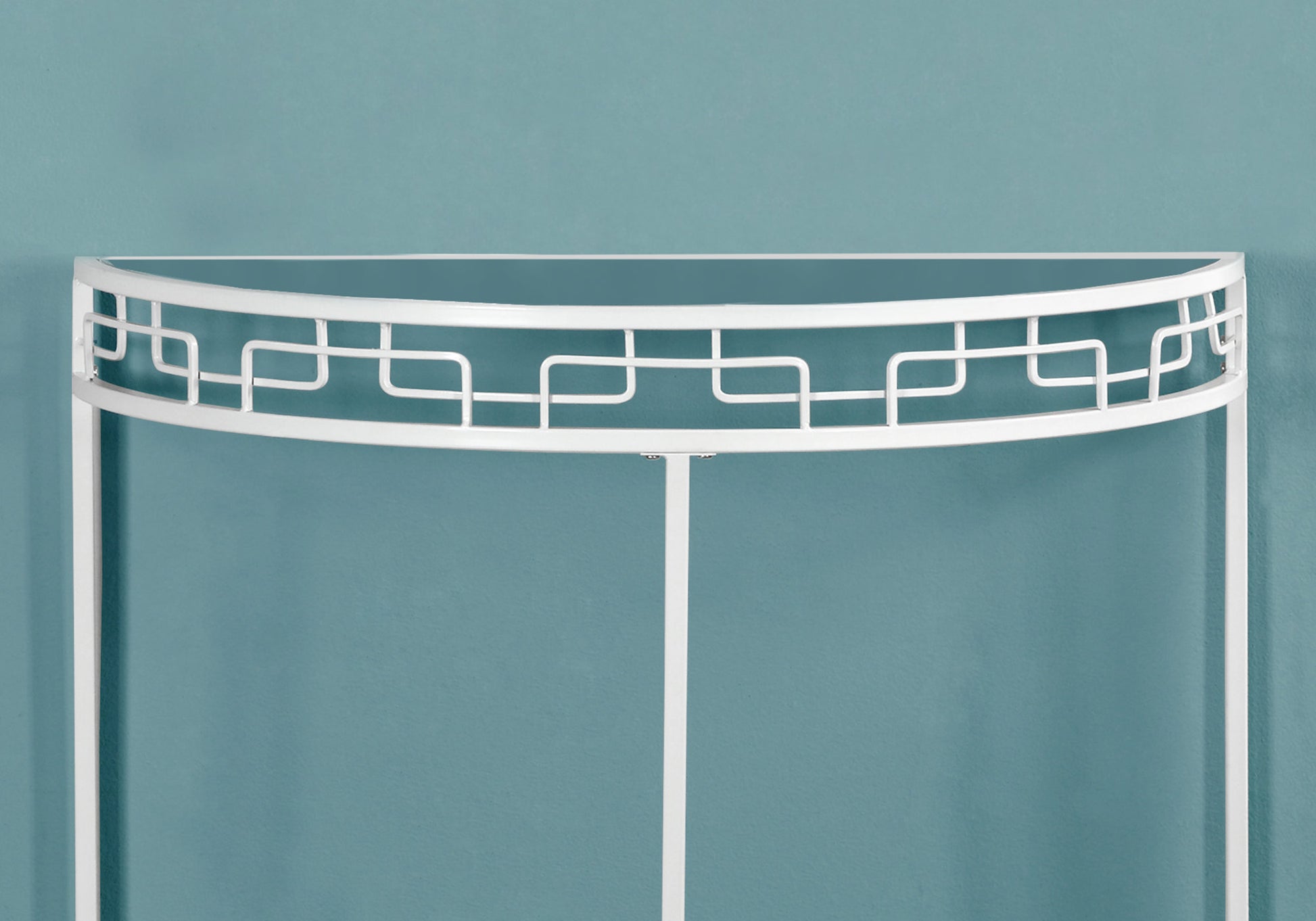 White metal console table with ornate geometric detailing and glass top