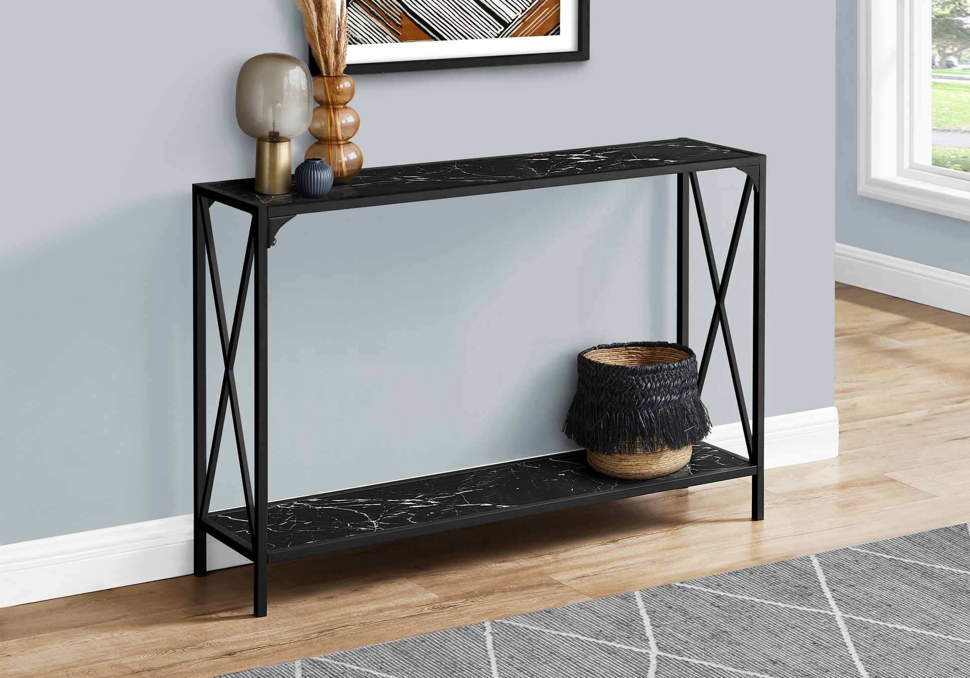 Black marble effect console table with black metal frame and crisscross legs