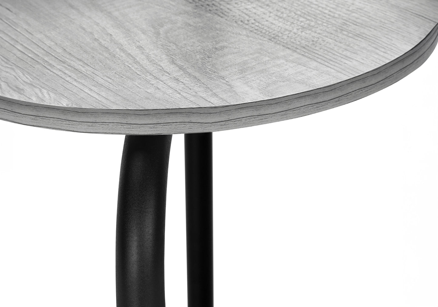 Closeup of a round grey wood grain side table top with black metal legs