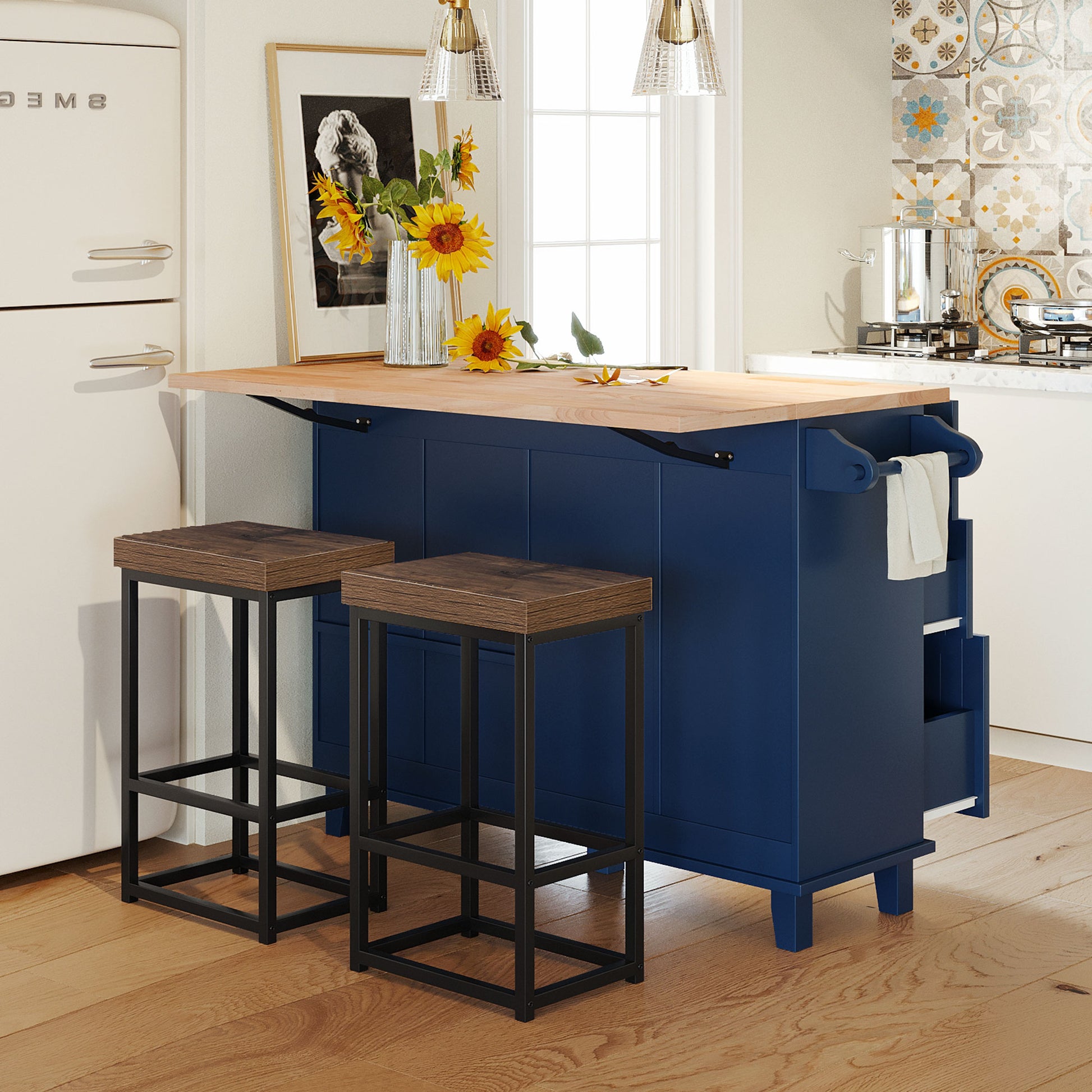 Navy blue kitchen island with butcher block countertop and two dark wood bar stools