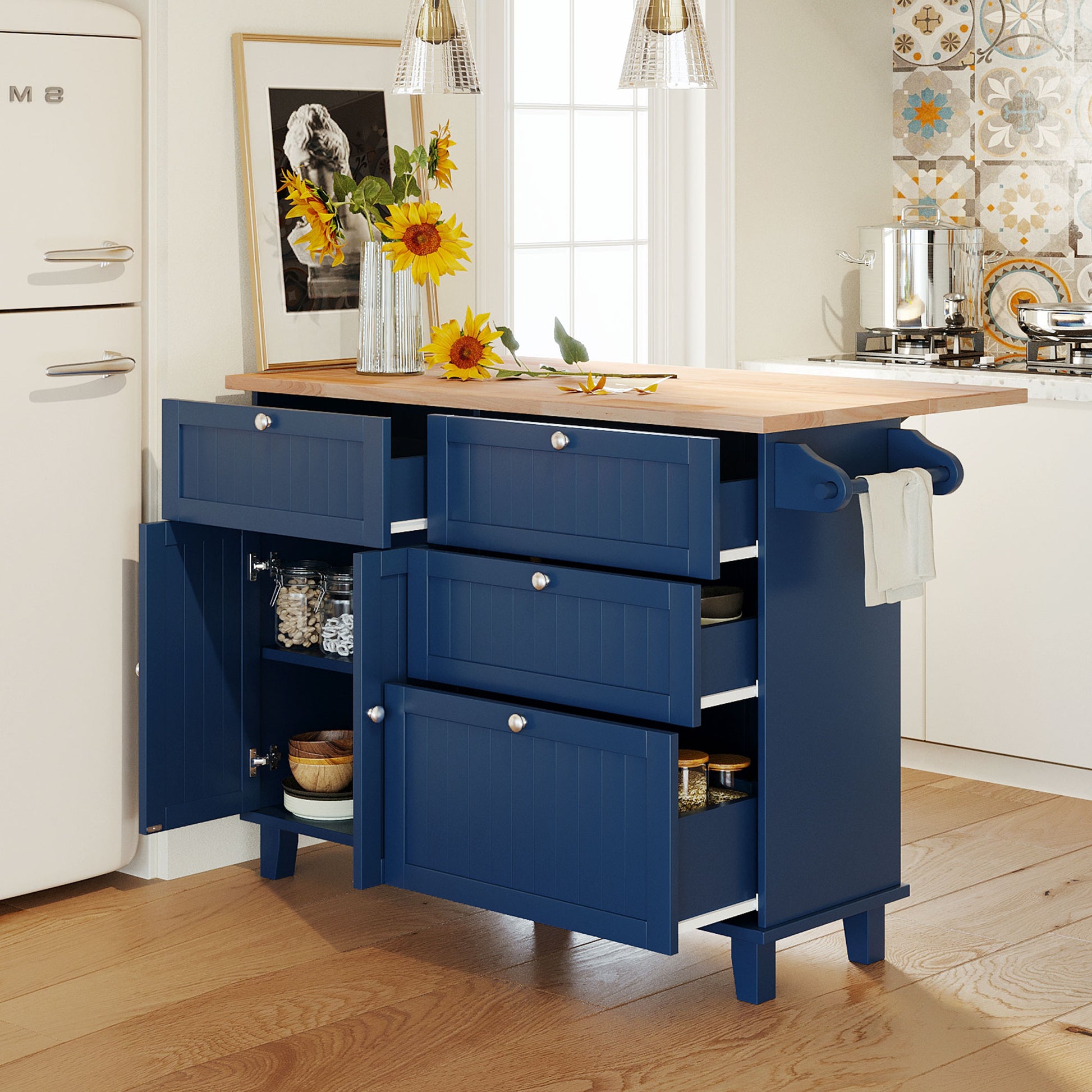 Navy blue kitchen island with butcher block top and open drawers