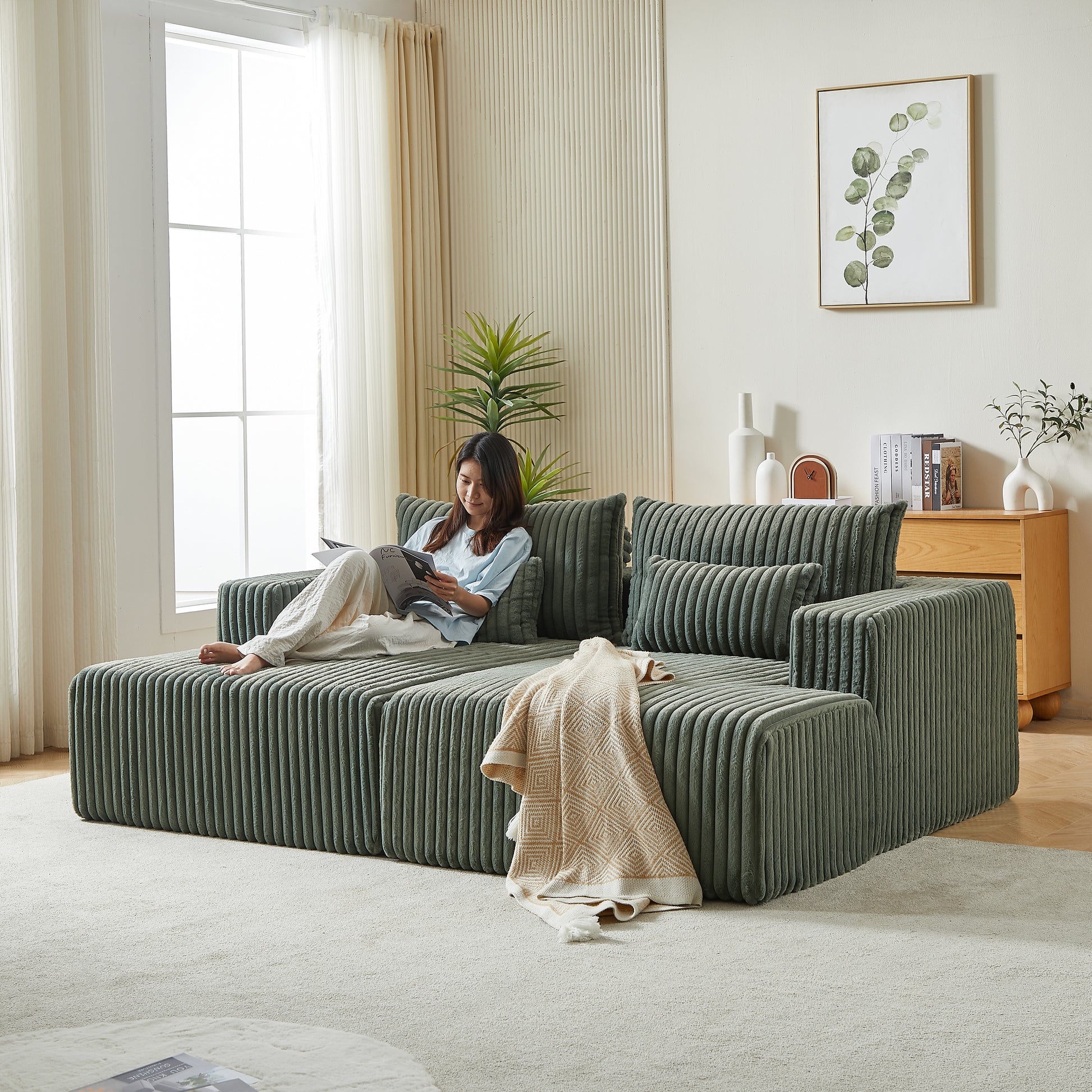 Sage green corduroy modular sofa with plush cushions and a throw blanket perfect for modern living rooms