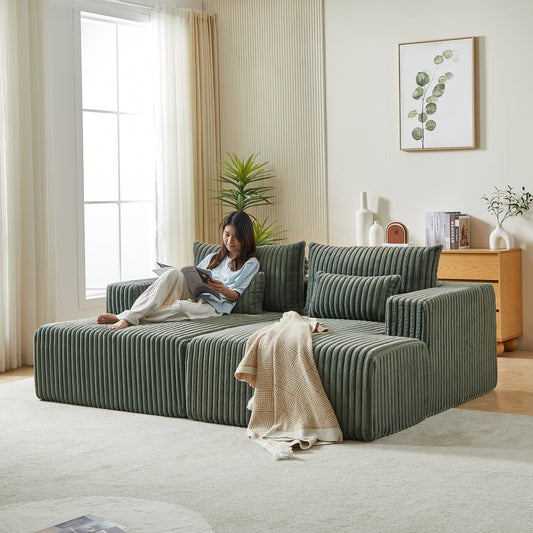 Sage green corduroy modular sofa with plush cushions and a throw blanket perfect for modern living rooms