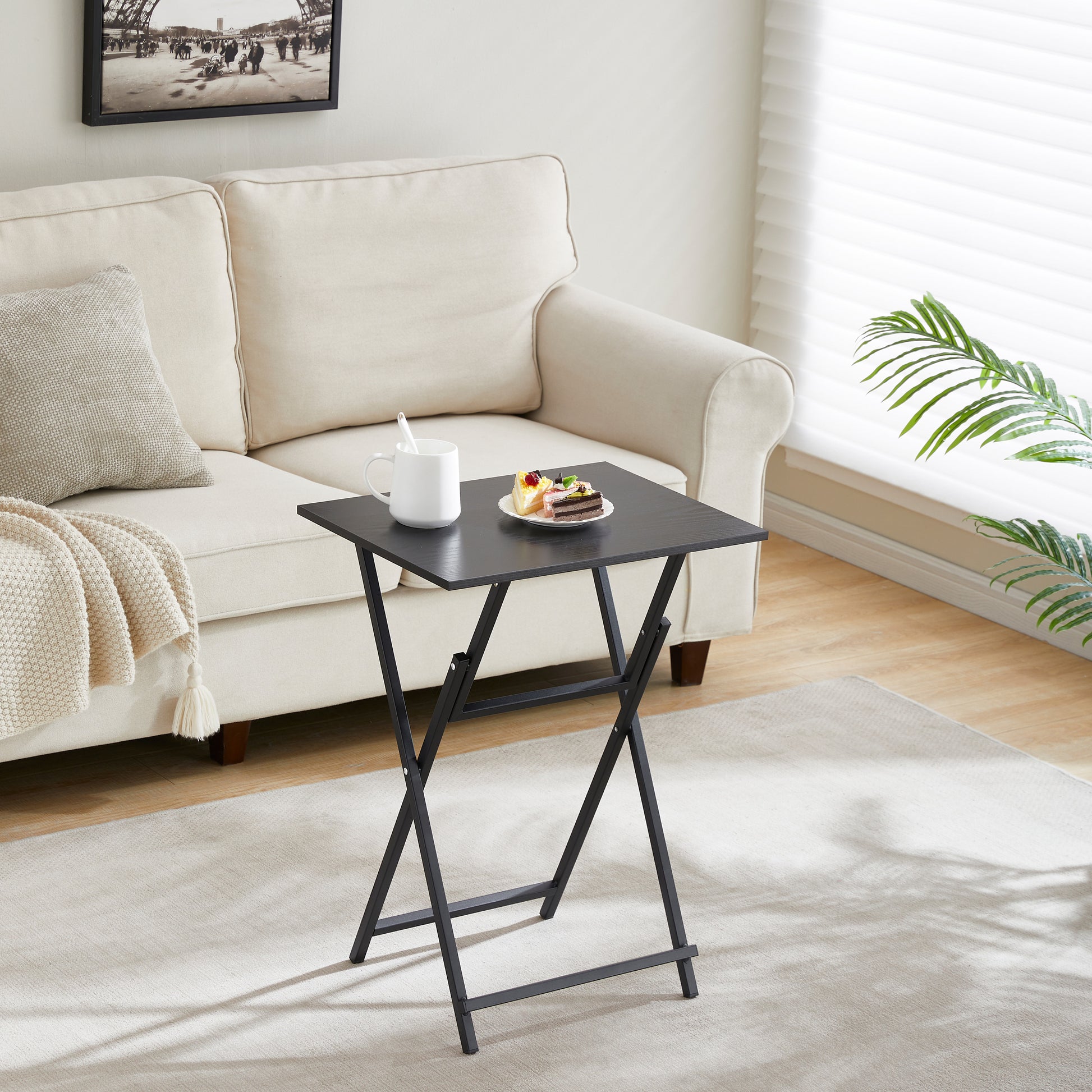 Black folding tray table with a textured woodgrain finish ideal for snacks