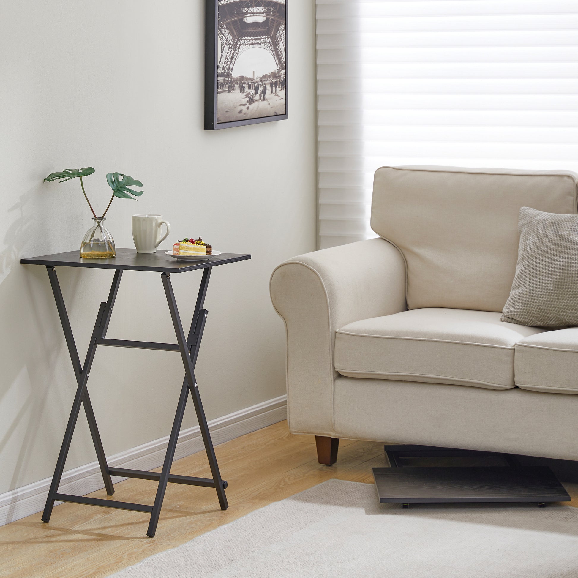 Black folding tray table with metal legs ideal for snacks and drinks