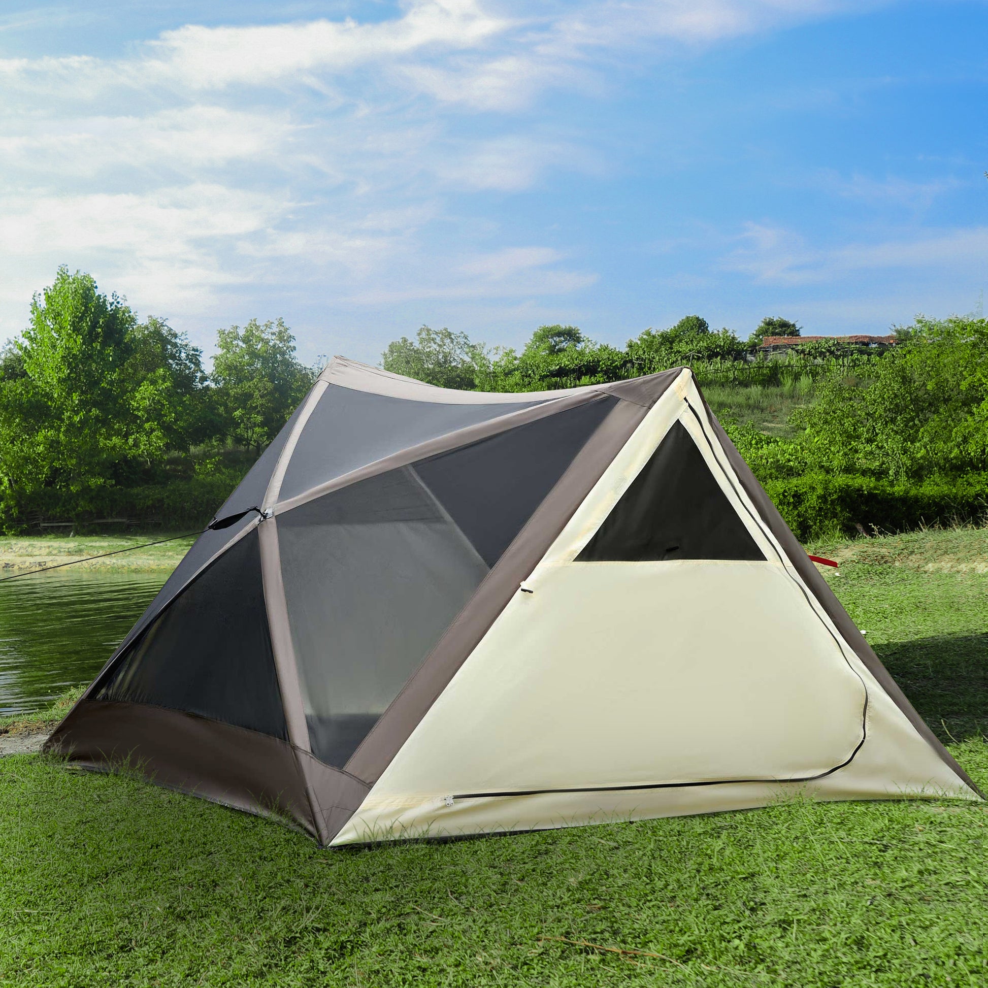 Tan and grey geodesic dome tent set up on grass by a lake ideal for camping