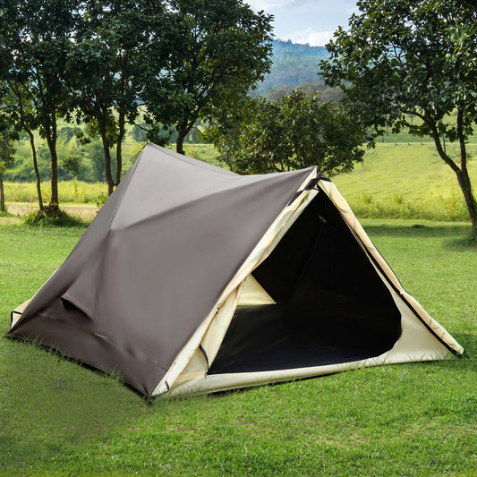 Brown and beige camping tent pitched on green grass with trees