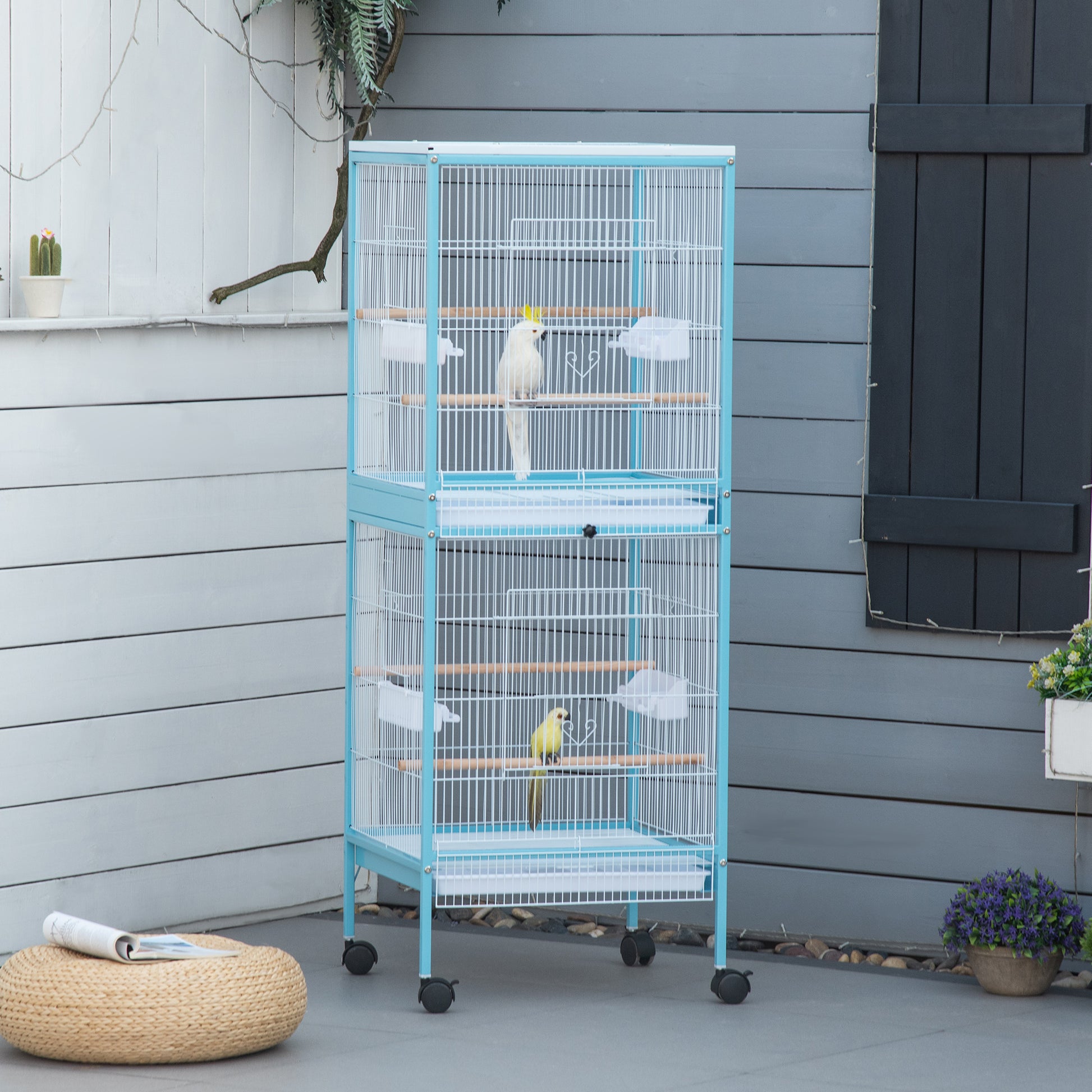 Twotier blue metal bird cage with white wire perches and two parrots
