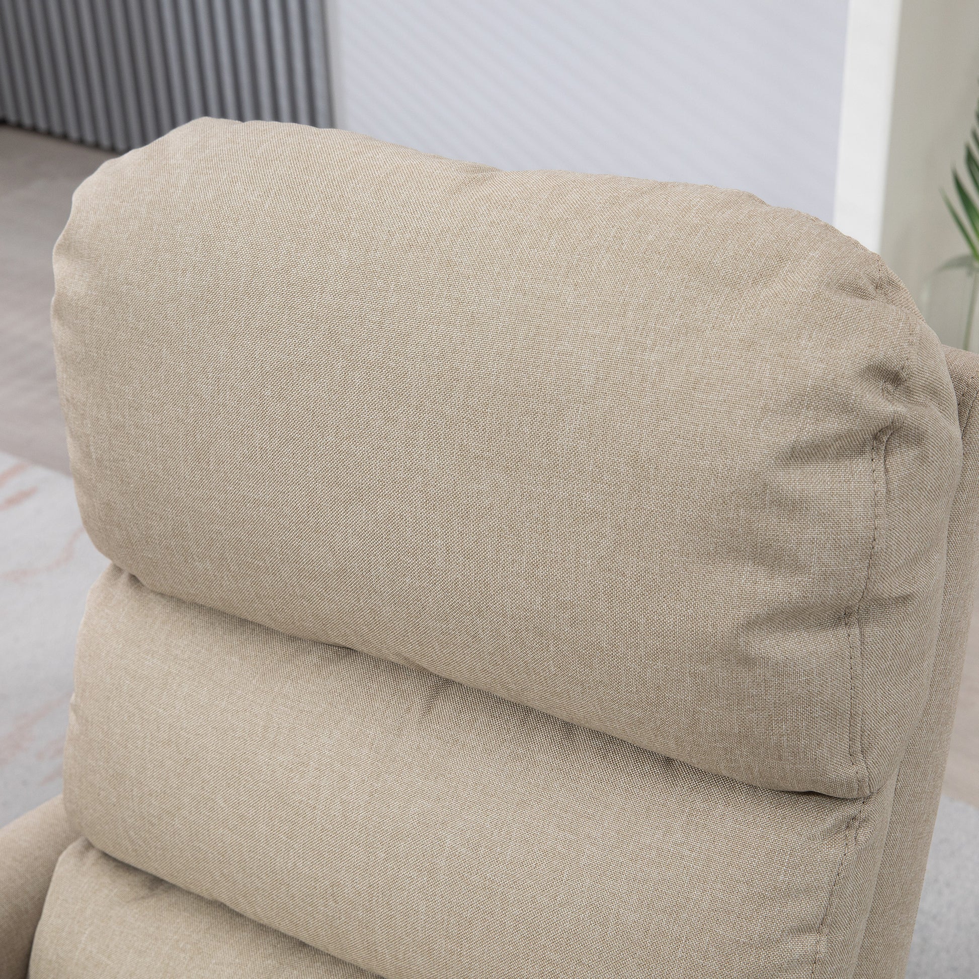 Closeup of plush beige fabric recliner headrest perfect for living room comfort