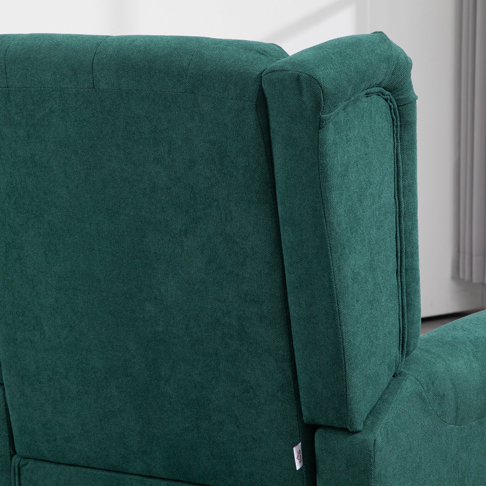 Dark green fabric sofa detail with plush texture and stitching for living room comfort