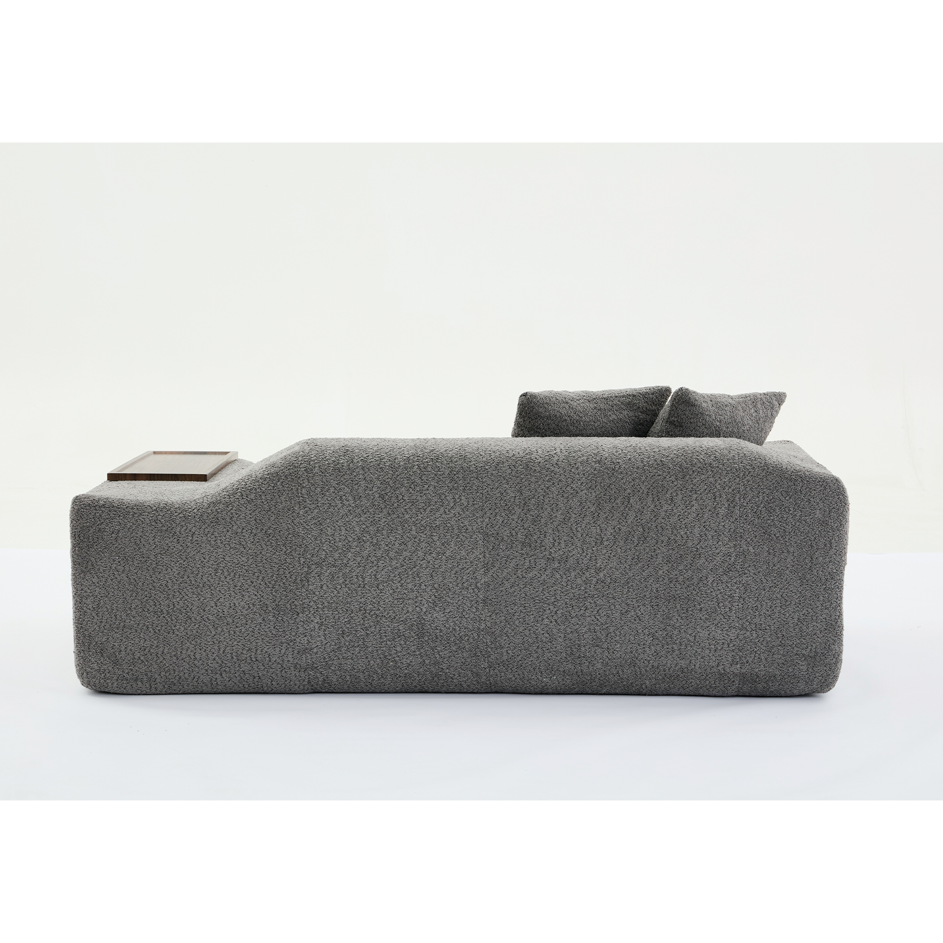 Modern grey boucle sofa with integrated wooden tray and plush cushions