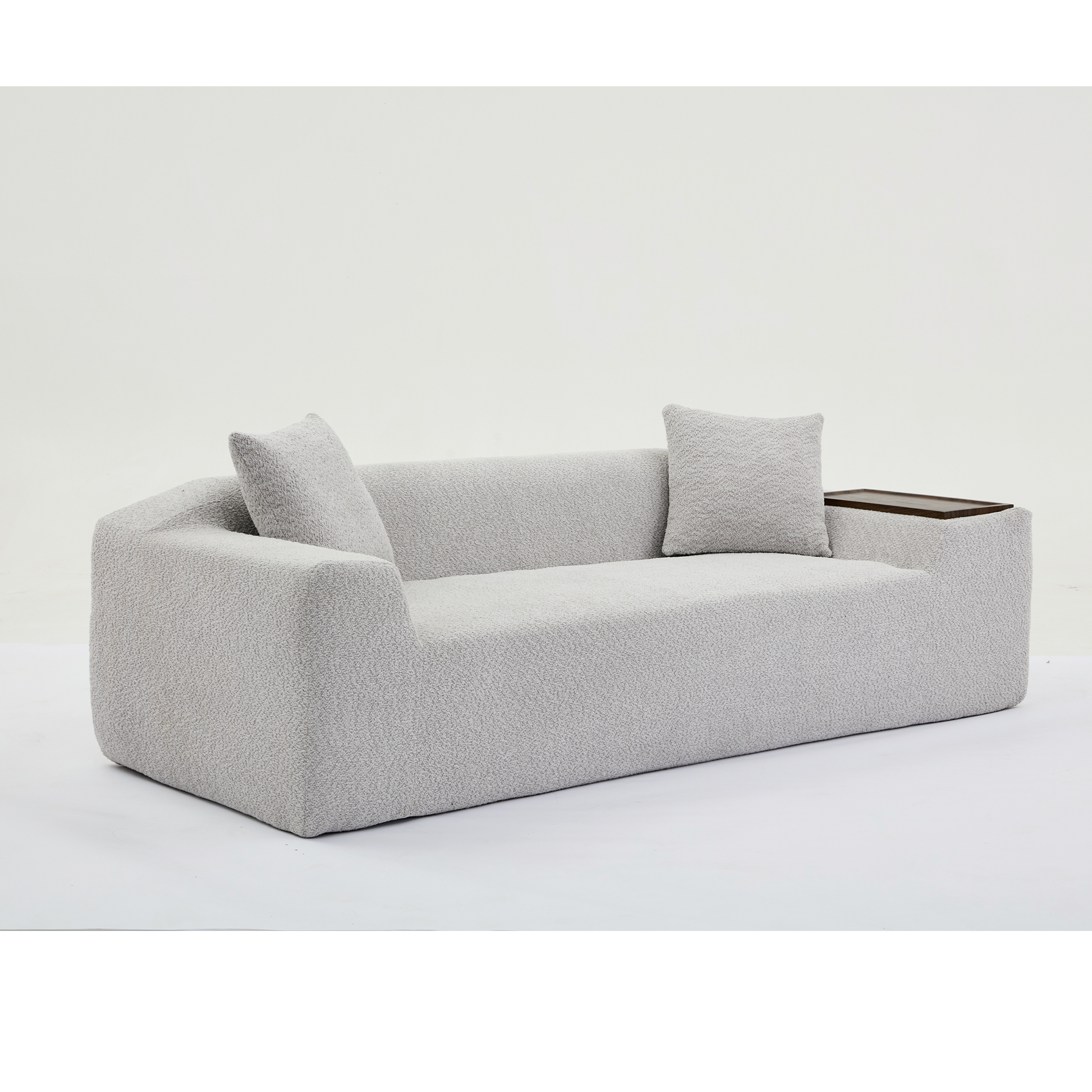 Light grey boucle sofa with modern design and integrated side table ideal for living rooms