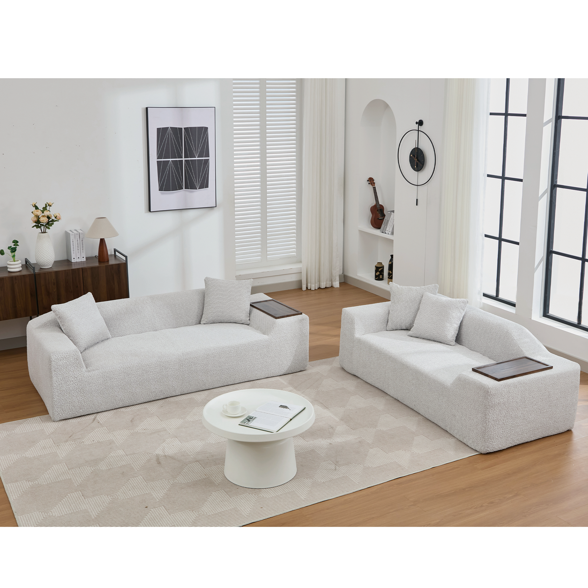 Soft grey boucle sectional sofa with two complementing throw pillows and a wooden armrest tray