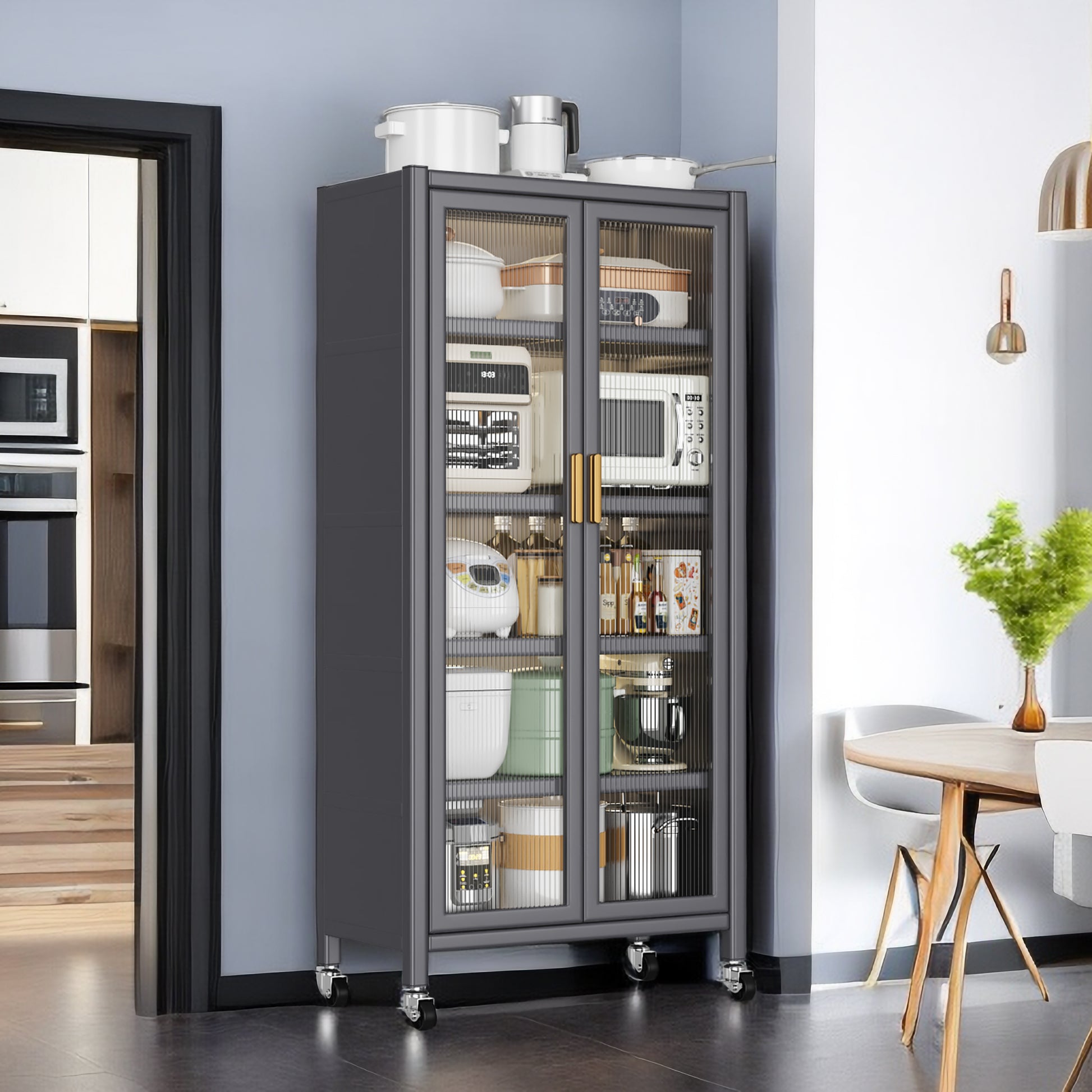 Gray metal kitchen storage cabinet with glass doors filled with appliances and cookware