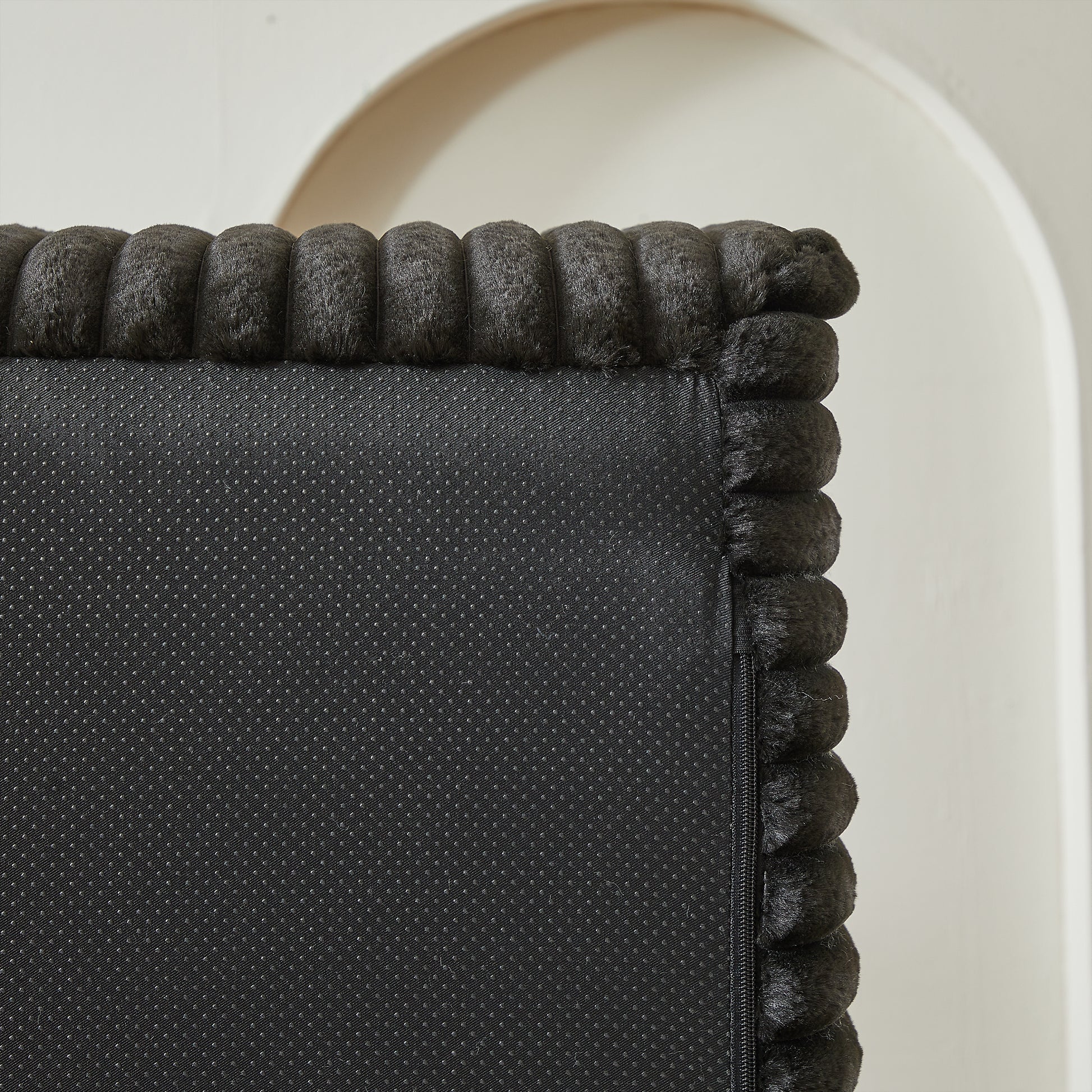 Dark grey plush trim on a black fabric base with antislip dots likely a pet bed accent