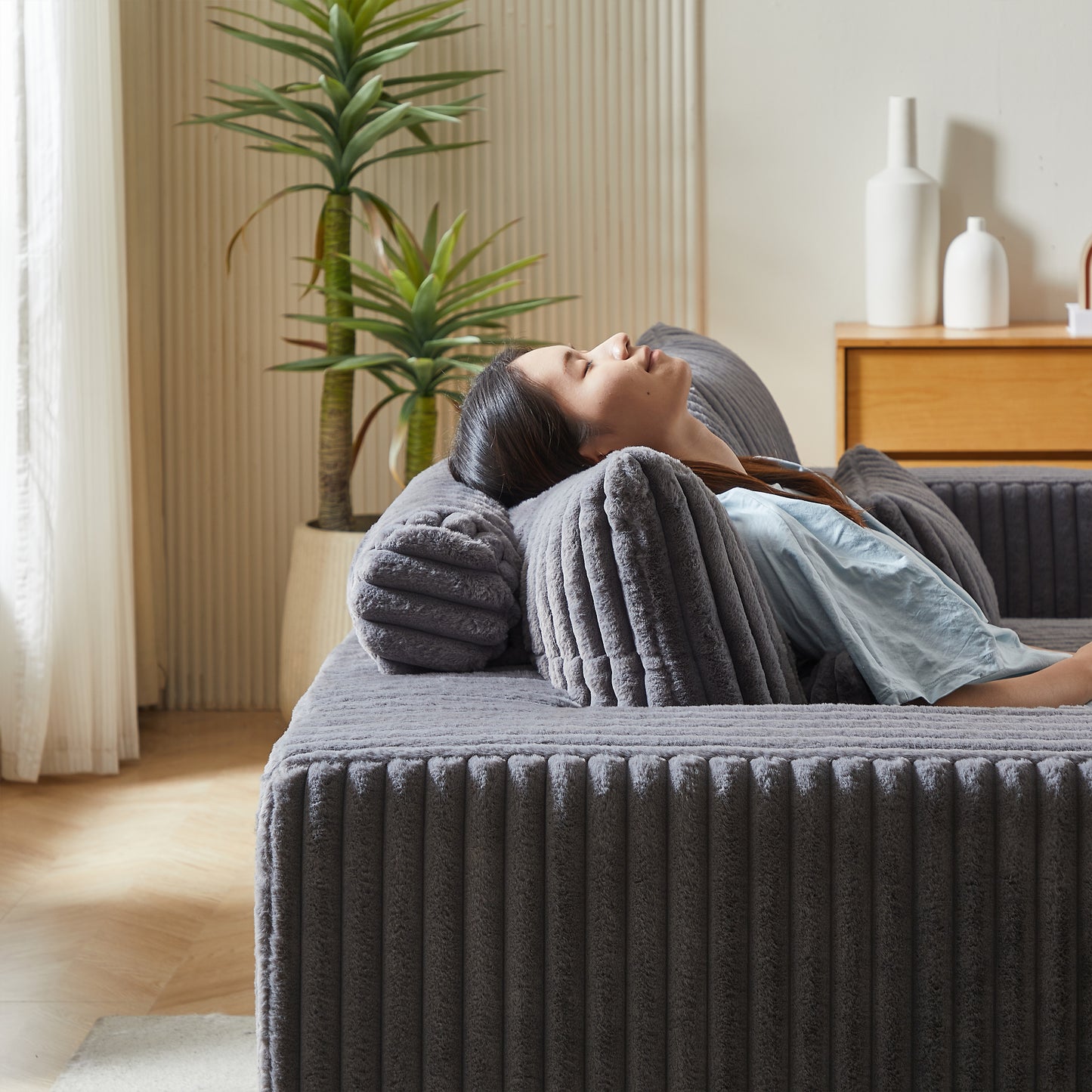 Plush corduroy sofa in dark gray featuring deep channeling and plush cushions for ultimate comfort