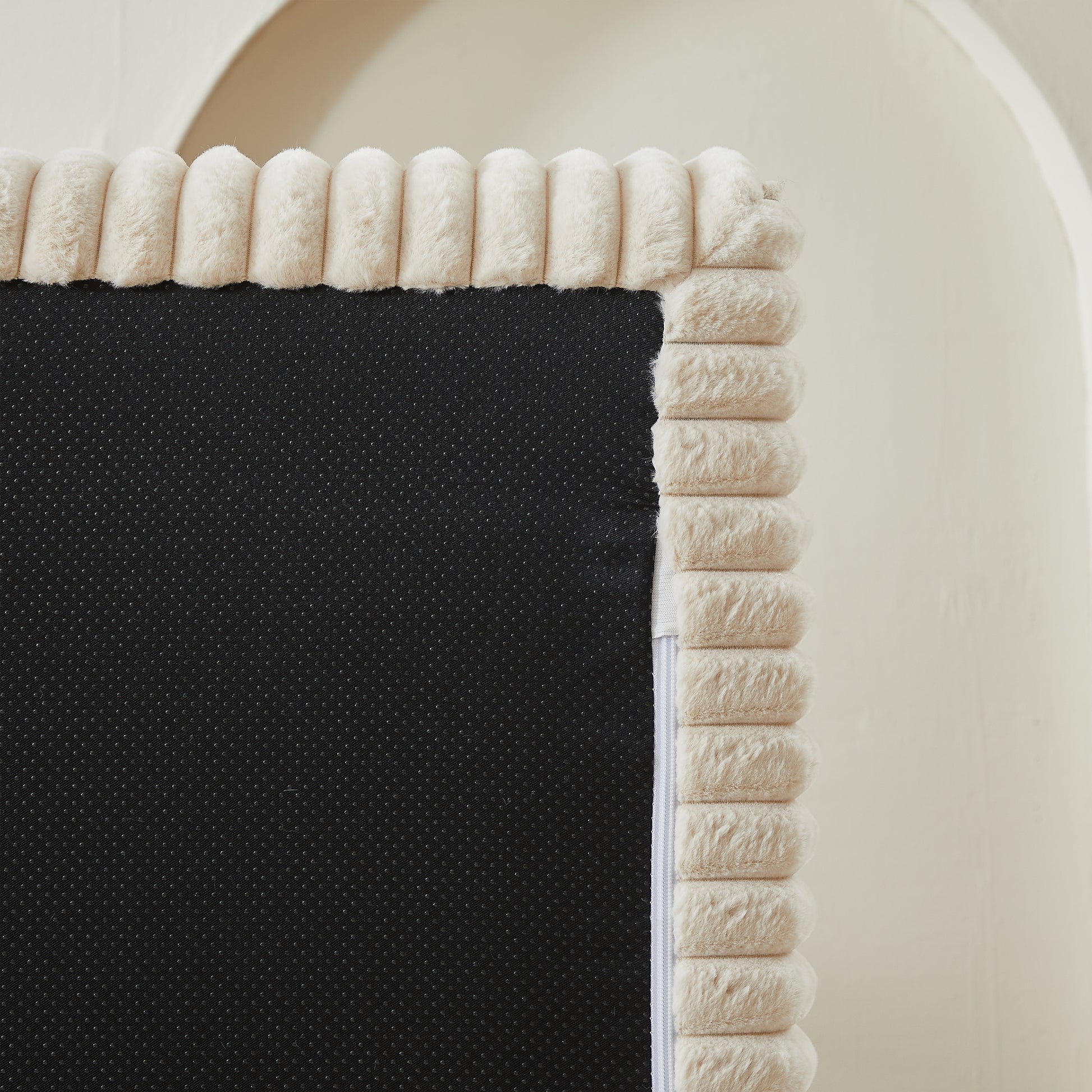 Cream plush ribbed trim on a black nonslip rug backing