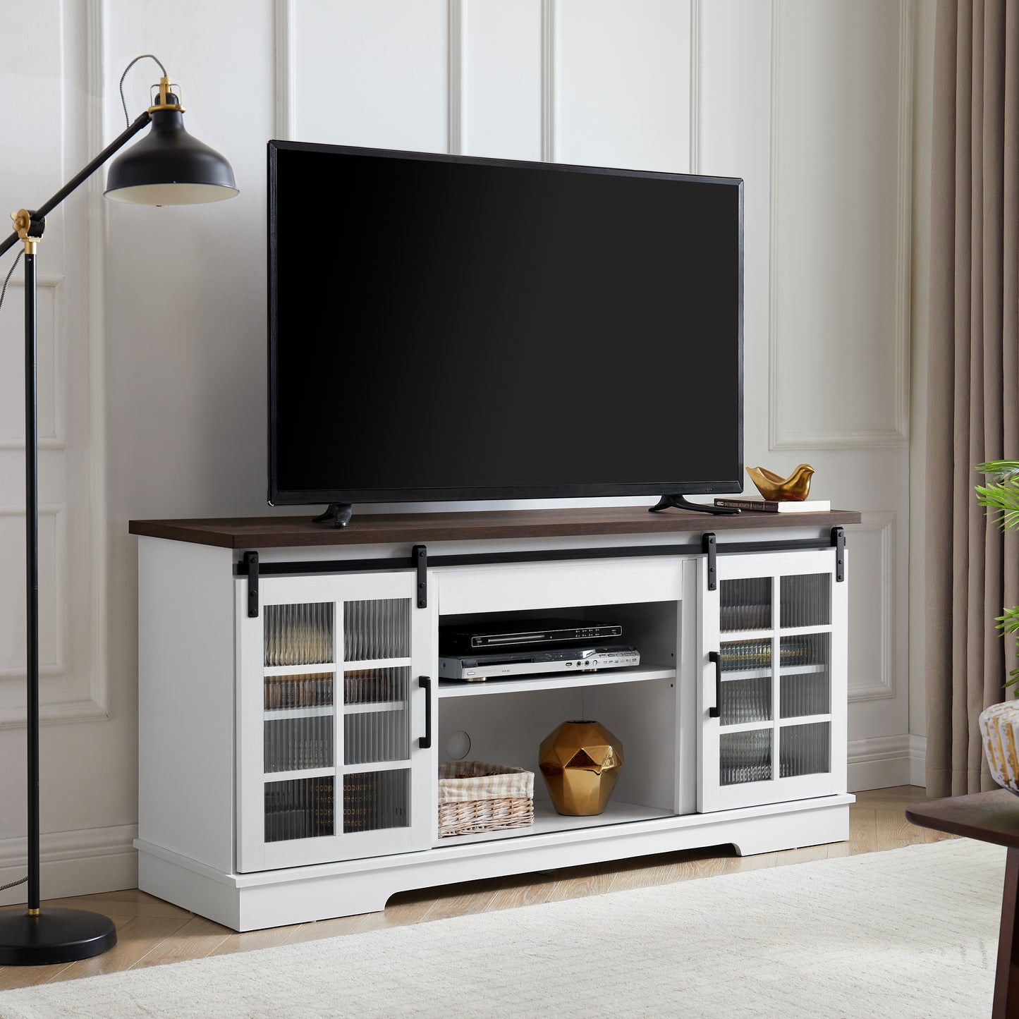 White barn door TV stand with dark wood top glass cabinet doors and storage shelves