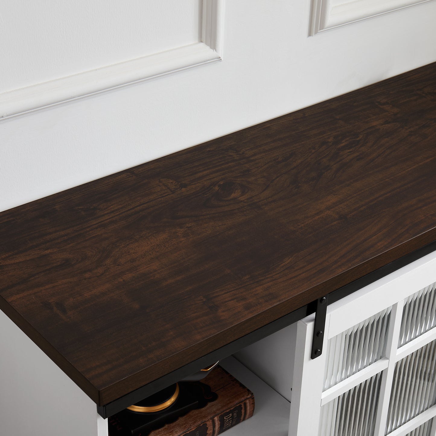 Dark wood grain textured countertop on a white console table with fluted glass doors