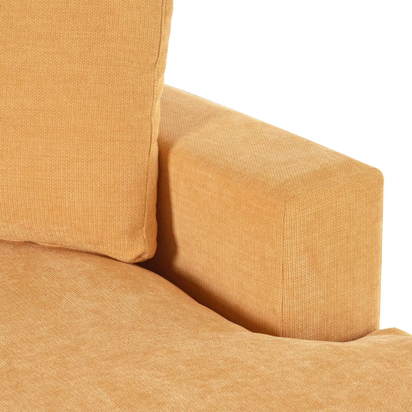 Closeup of textured orange velvet sofa arm and cushion