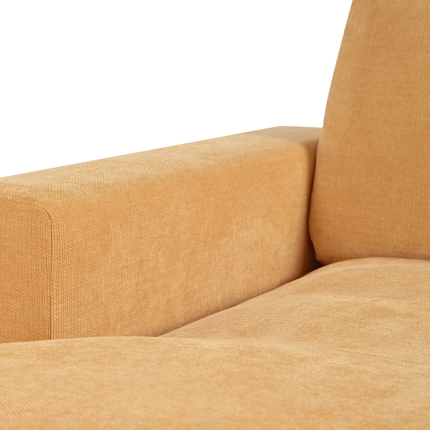 Closeup of textured ochre velvet fabric on a modern sofa armrest