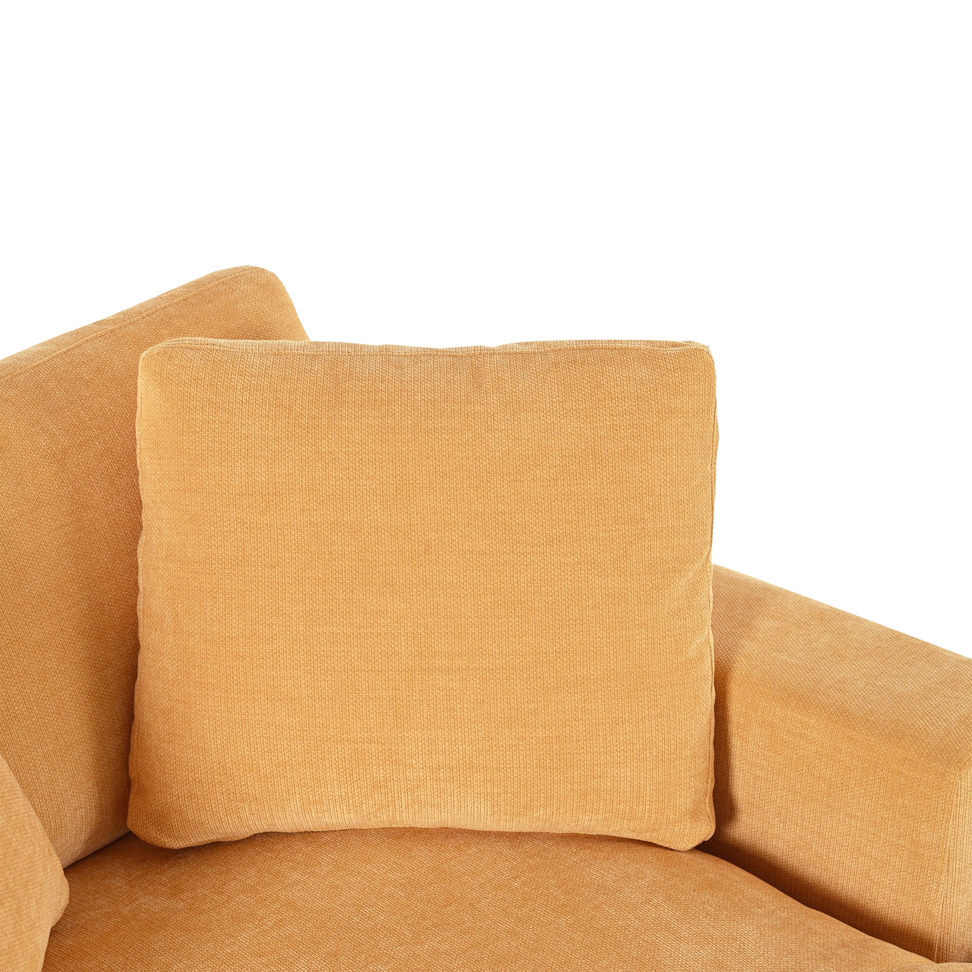 Close up of a plush orange velvet couch cushion with textured fabric