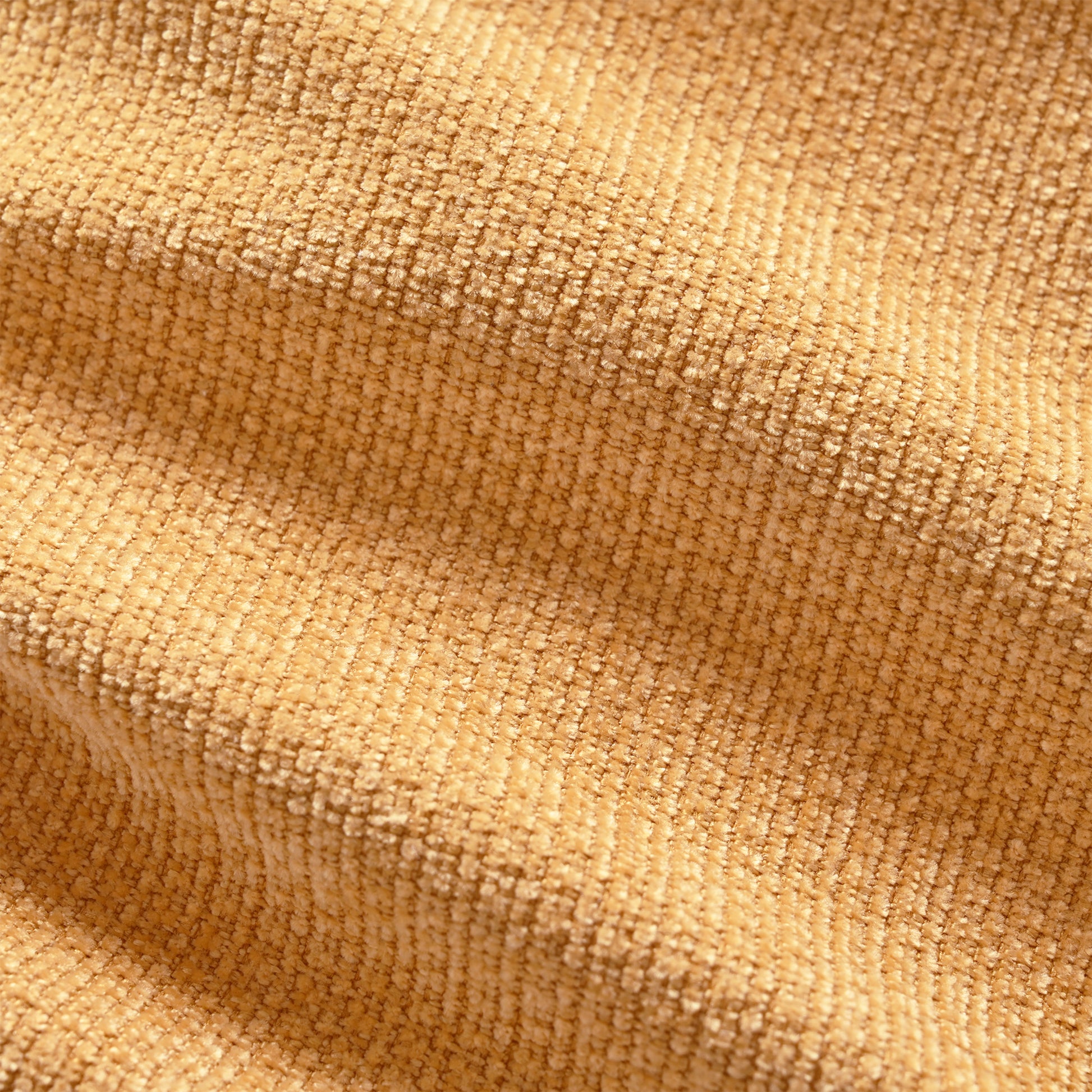 Closeup of textured camel brown corduroy fabric with raised ridges ideal for upholstery