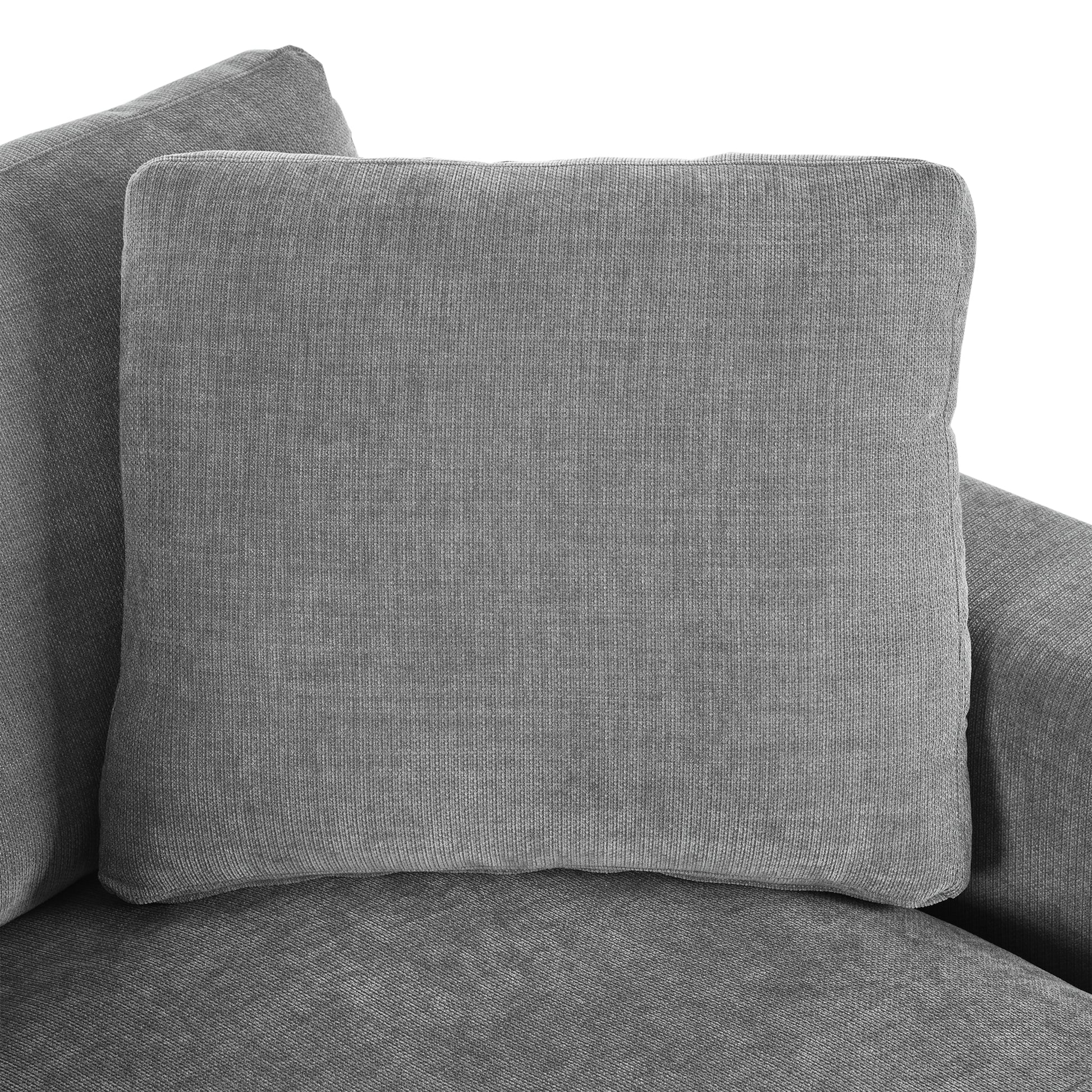 Closeup of a plush grey throw pillow with textured fabric perfect for sofa decor