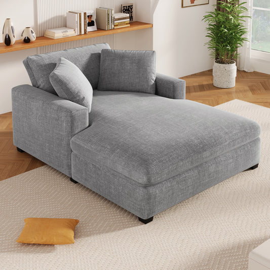 Grey fabric chaise lounge with plush cushions and modern design