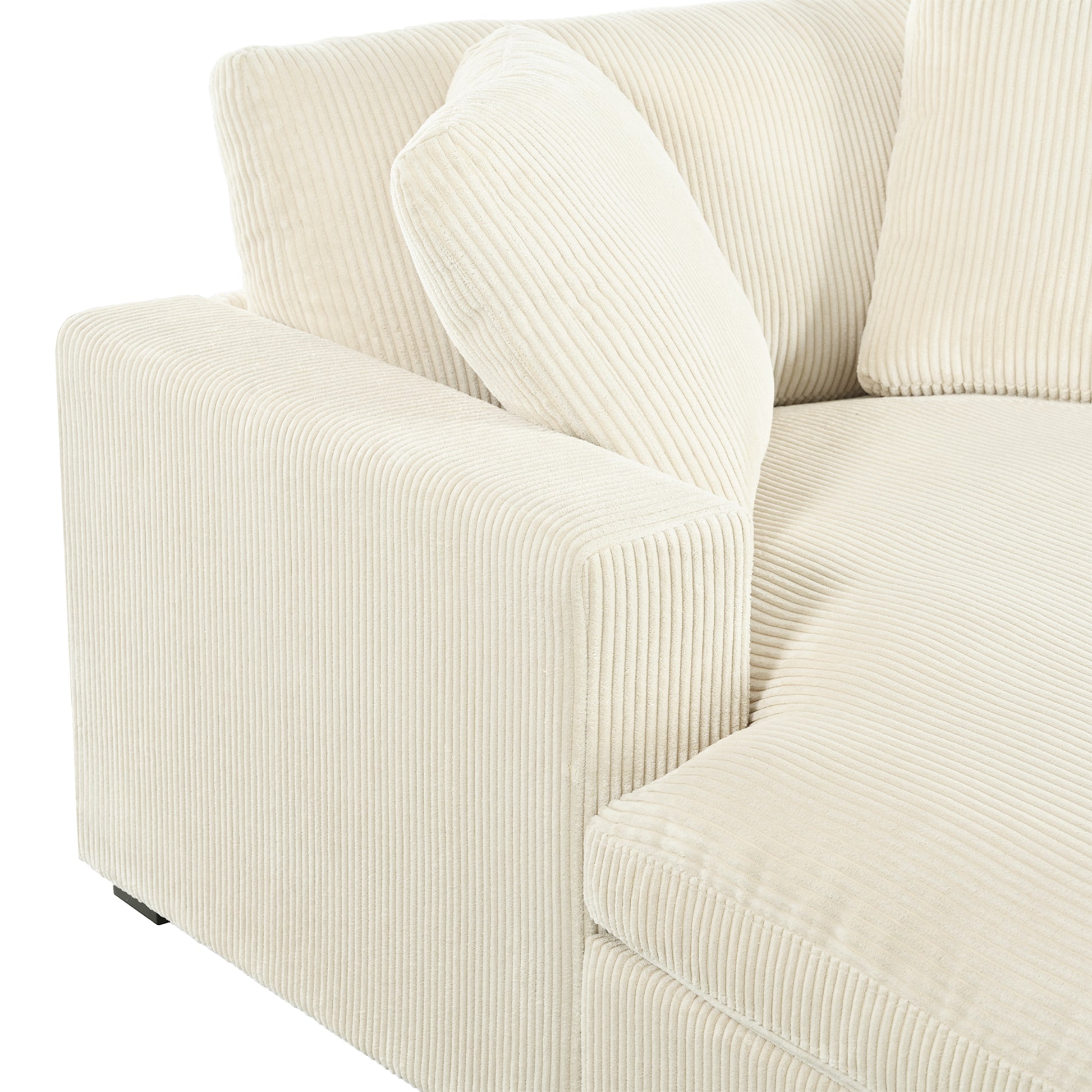 Cream corduroy sectional sofa with plush throw pillows on white background