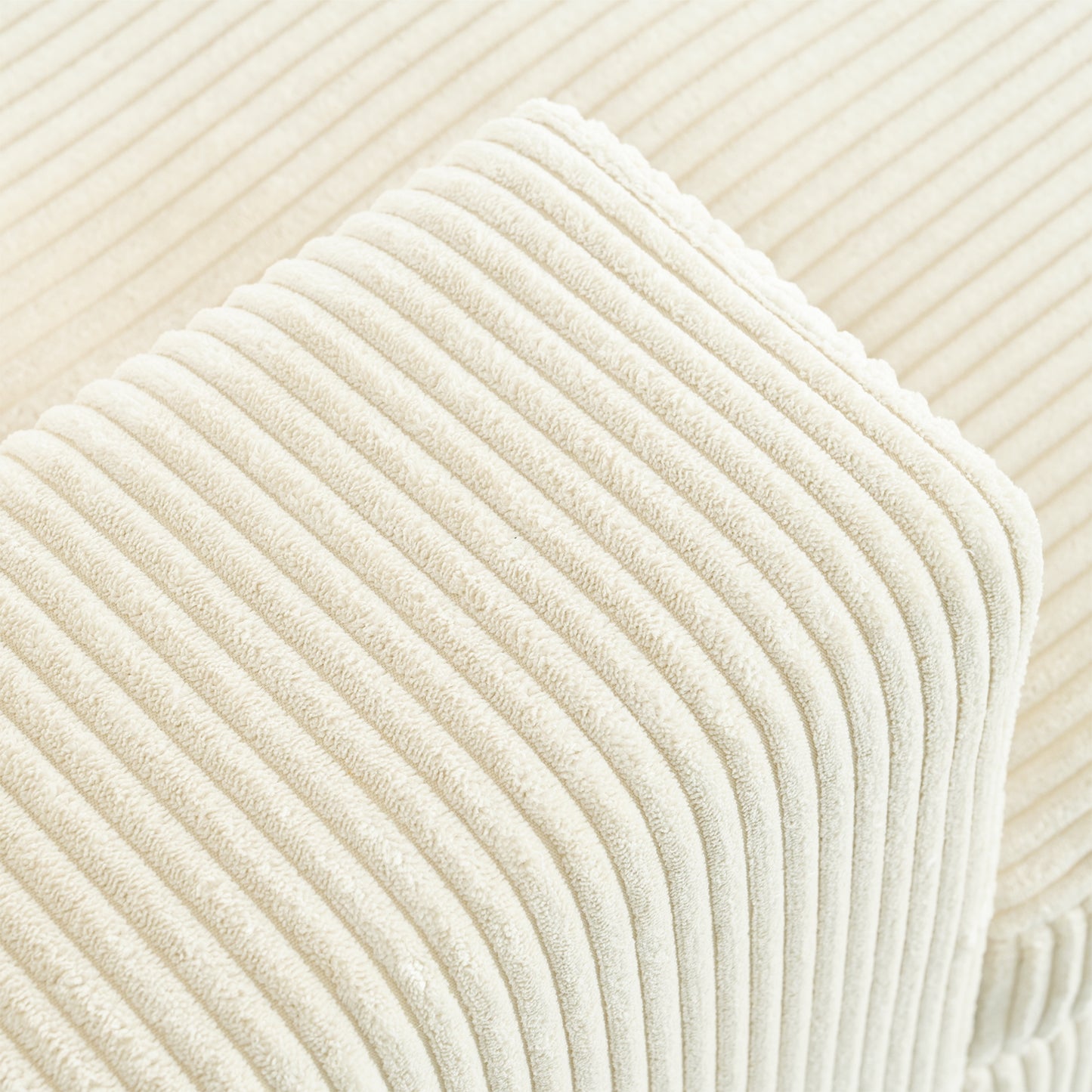 Closeup of cream corduroy fabric texture with a plush velvety feel and ribbed pattern