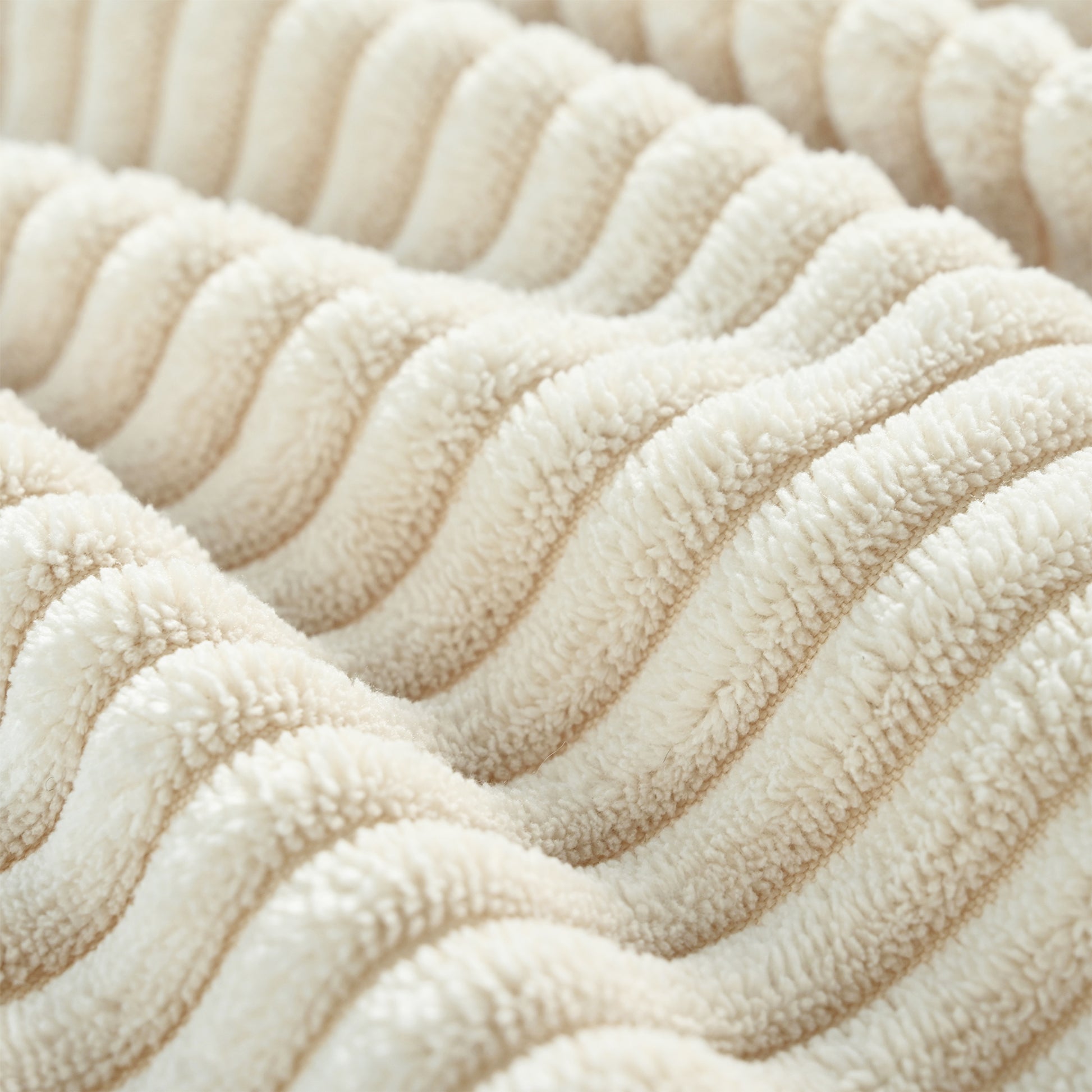 Plush cream sherpa fabric with vertical ribbed texture perfect for cozy blankets