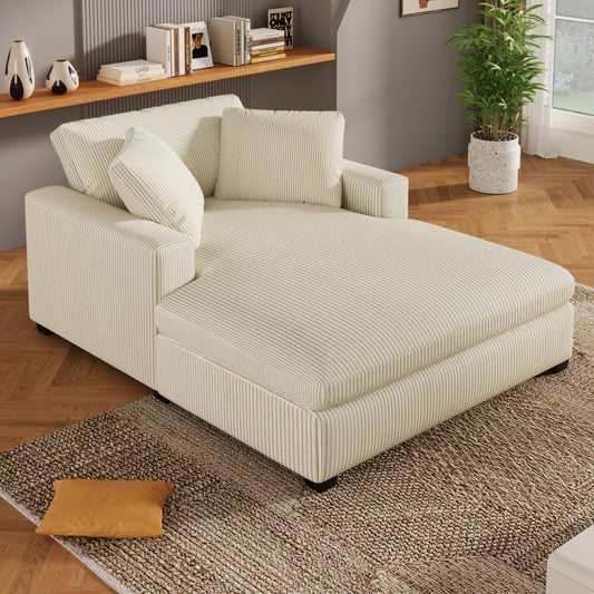 Cream corduroy chaise lounge with plush throw pillows and textured rug