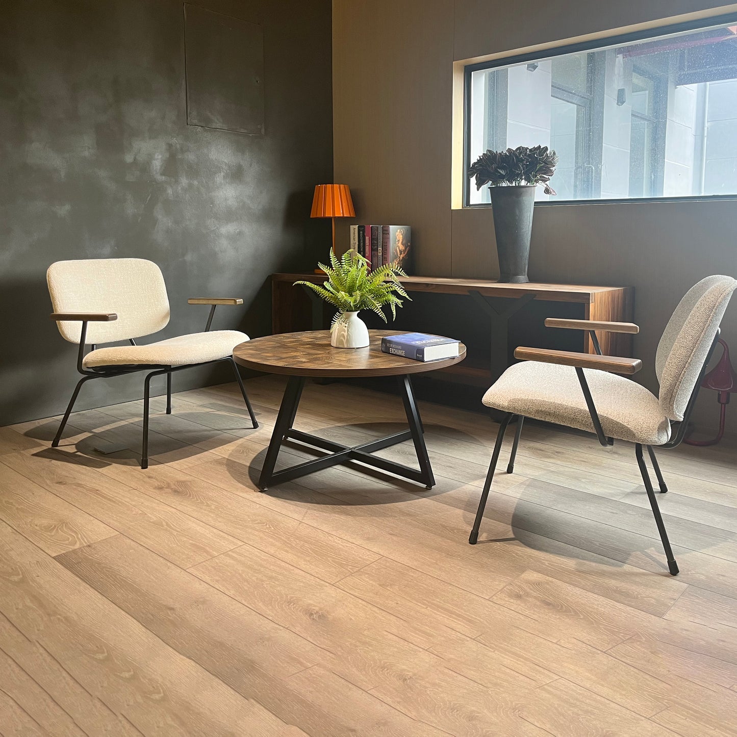 Modern beige upholstered accent chairs with dark metal frames and wood arms perfect for a living room