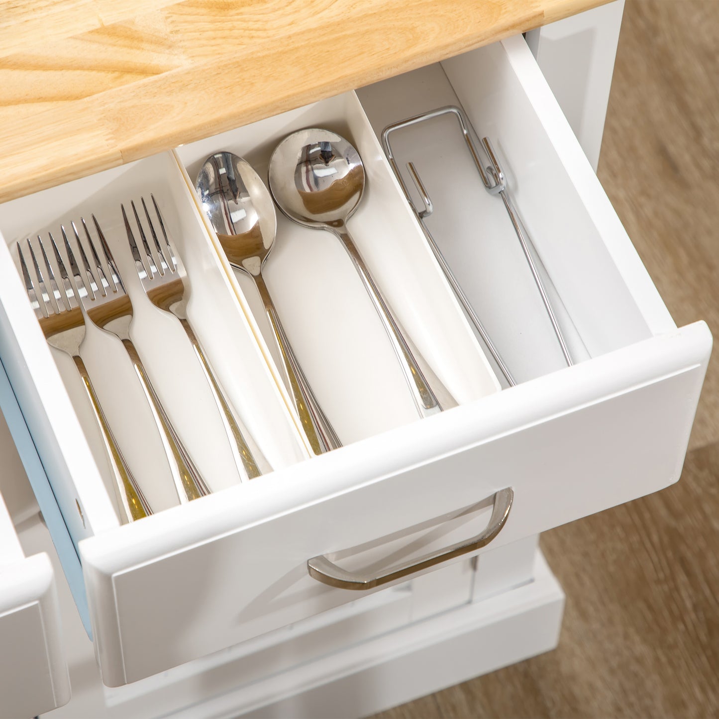 Set of polished stainless steel forks and spoons neatly arranged in a cutlery drawer
