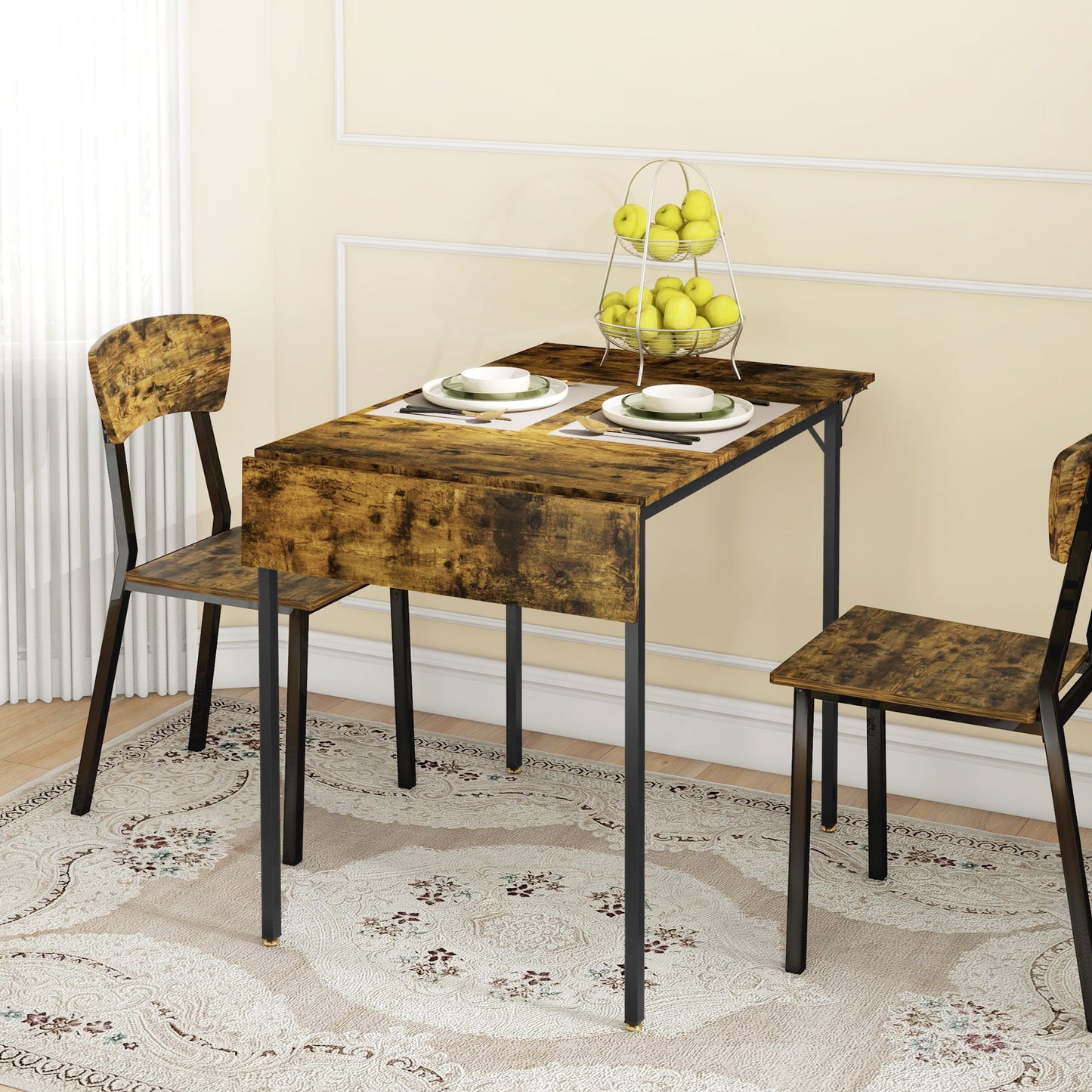 Rustic brown drop leaf dining table with two chairs and a fruit bowl