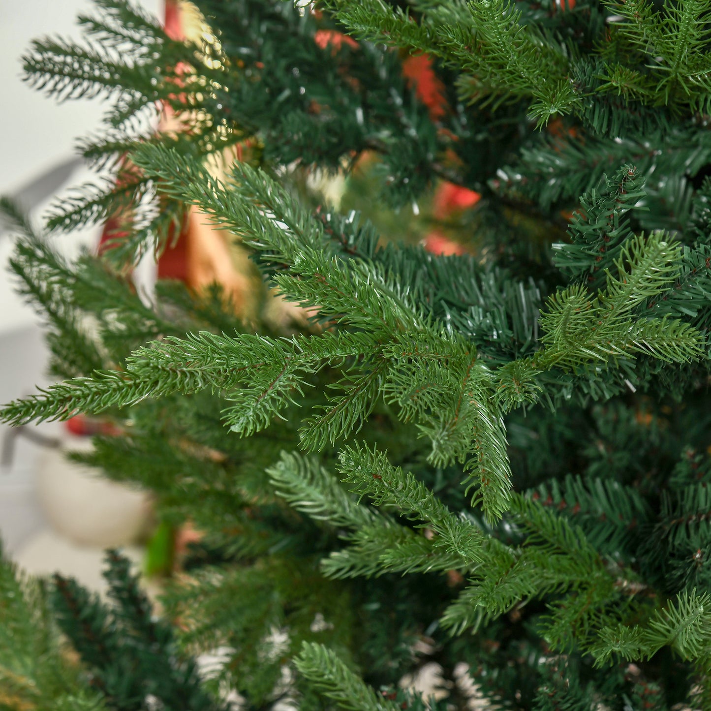 Closeup of realistic artificial Christmas tree branches deep green needles