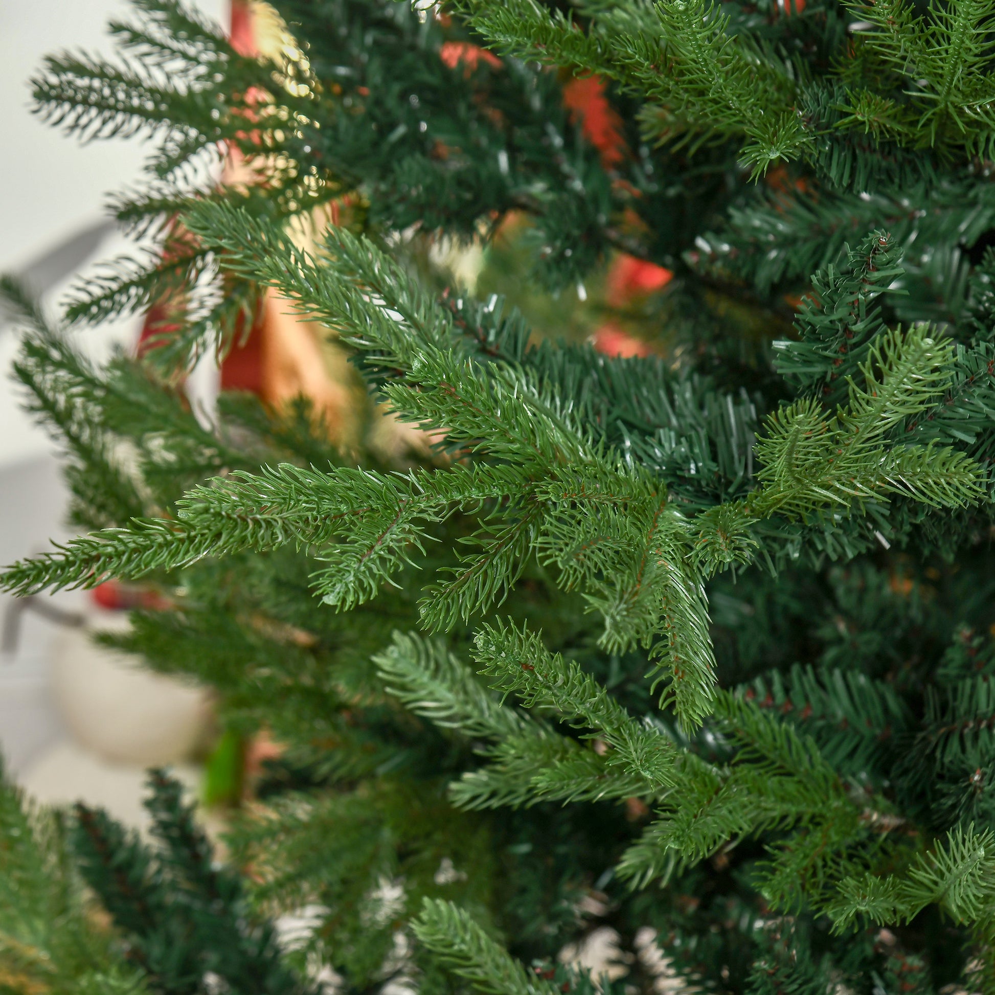 Closeup of realistic artificial Christmas tree branches deep green needles