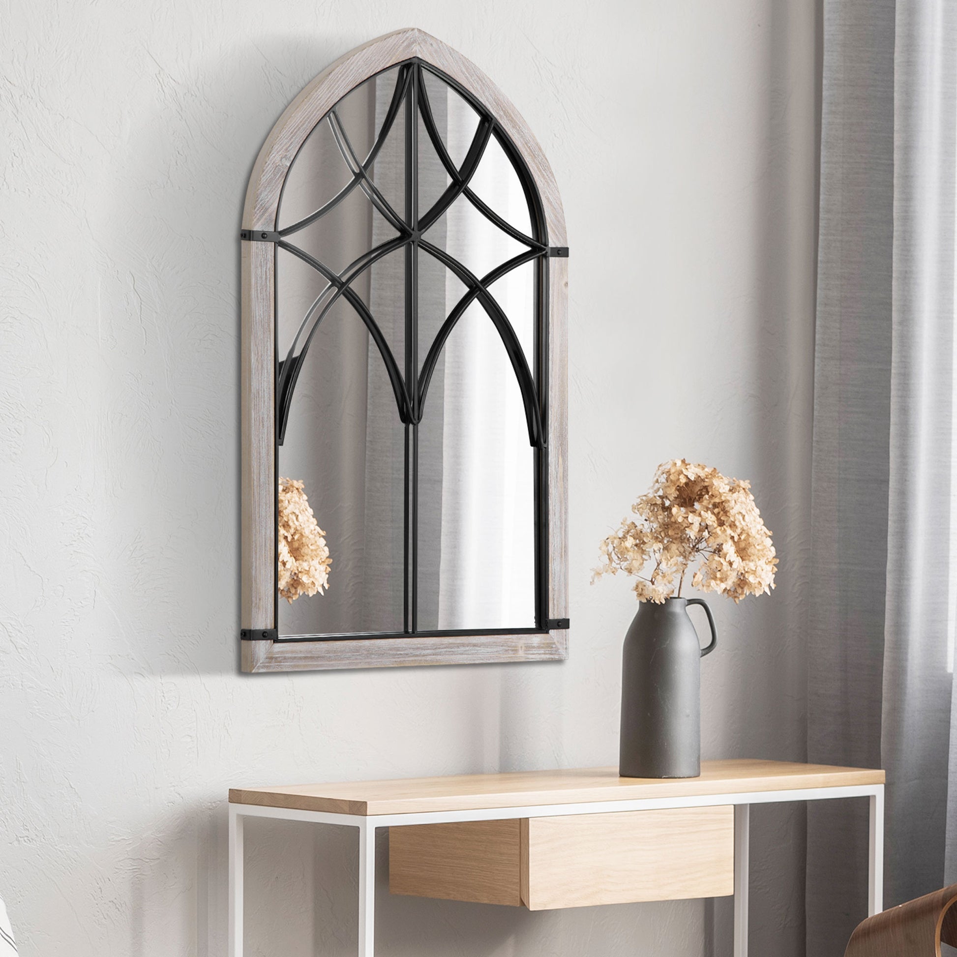 Gothic arched wall mirror with weathered wood frame and black metal accents