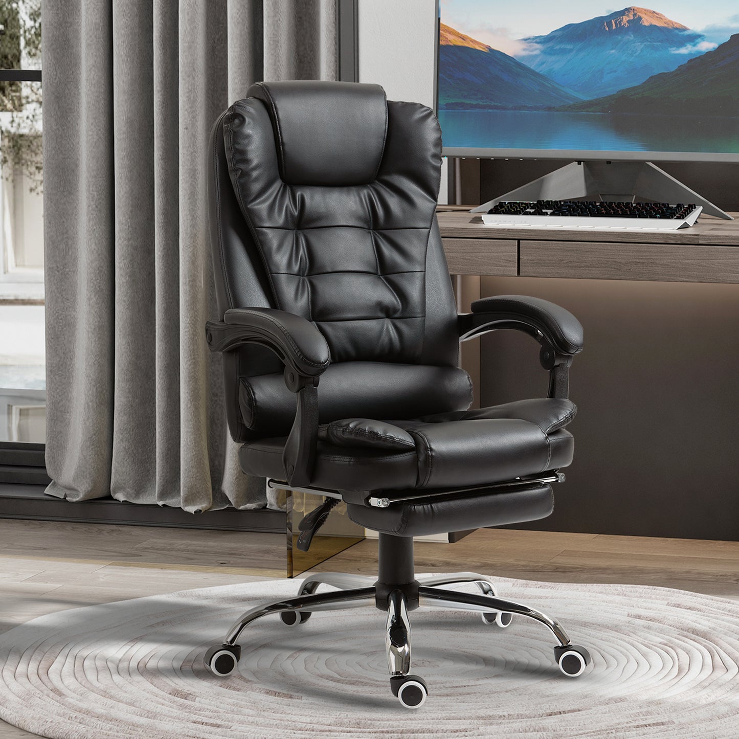Black executive office chair with padded faux leather adjustable footrest and lumbar support