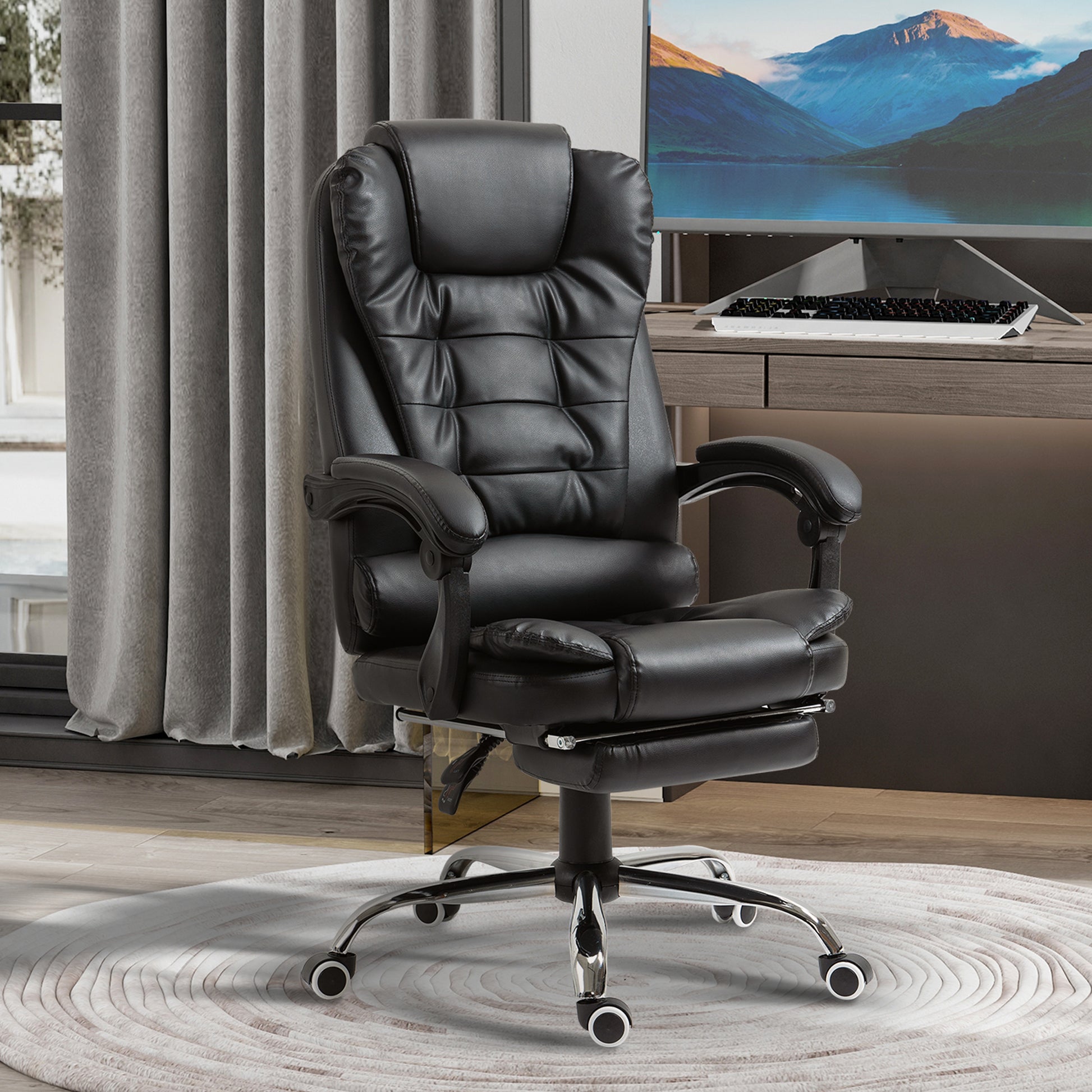Black executive office chair with padded faux leather adjustable footrest and lumbar support