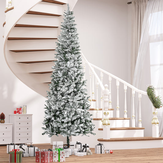 Flocked artificial Christmas tree with flocked branches set in a festive home entryway with gifts