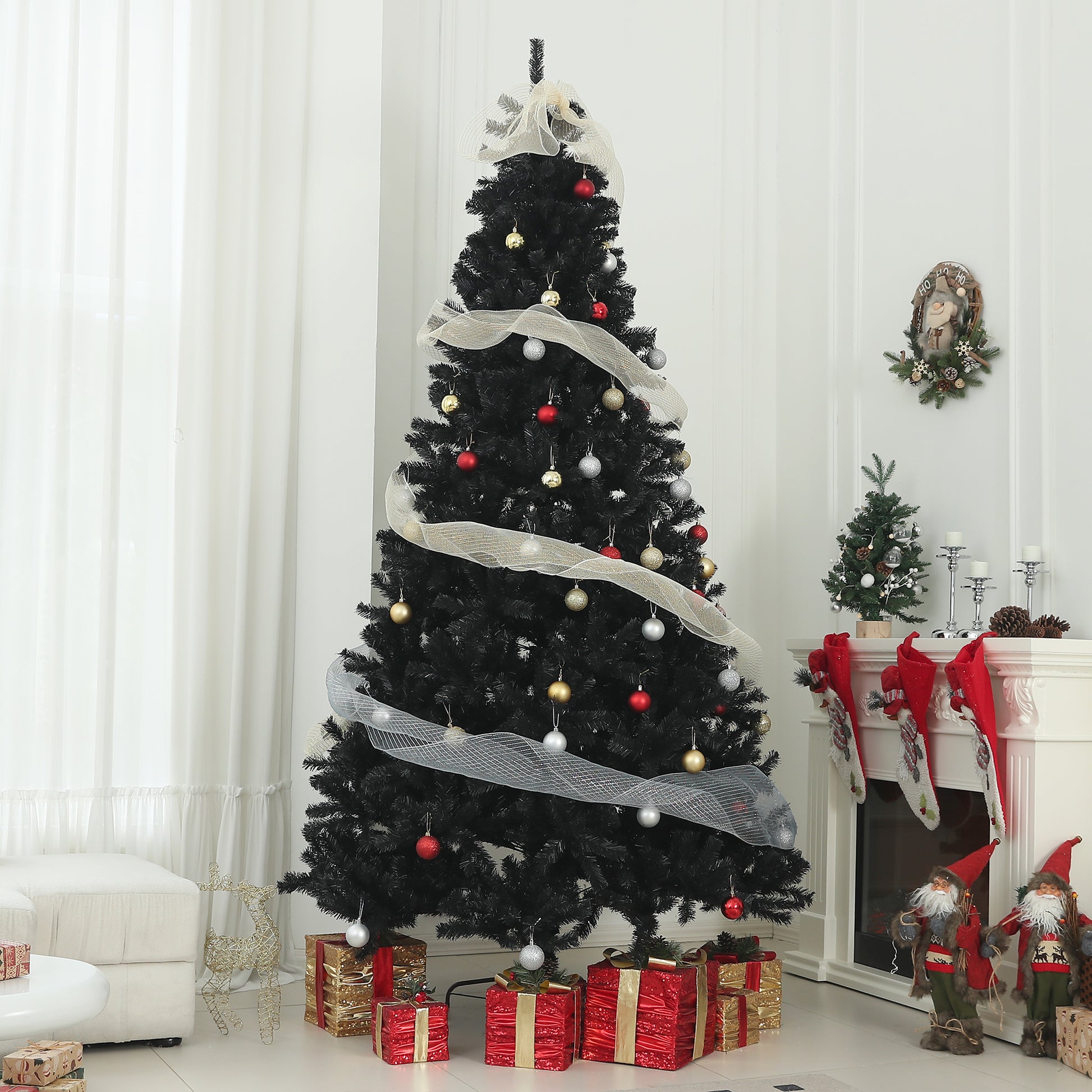 Black artificial Christmas tree with red gold and silver ornaments draped in mesh ribbon