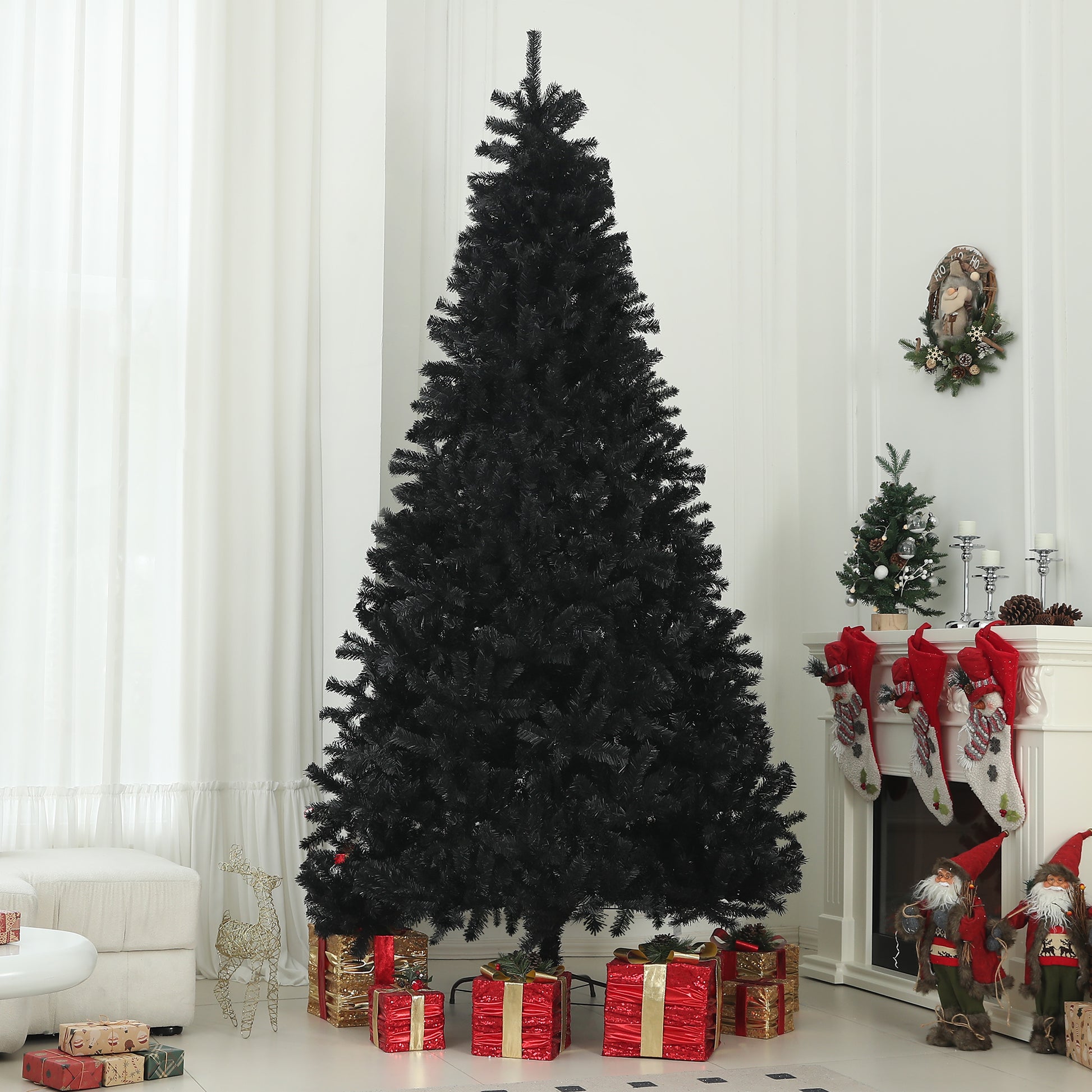 Full black artificial Christmas tree with red and gold gift boxes at the base